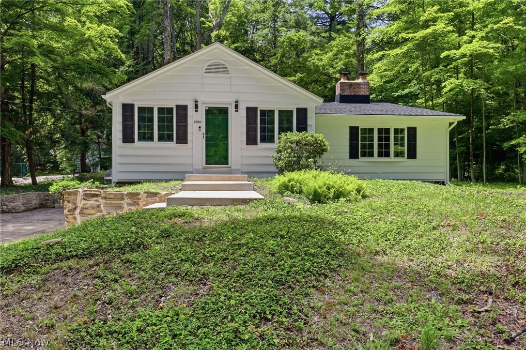 Welcome to 2020 Woodstock Road, a beautifully rebuilt ranch nestled on a private one-acre lot in Gates Mills' most sought-after location. Extensively renovated over the past year, this move-in-ready home showcases exceptional craftsmanship and quality updates, including a new roof, windows, garage door, hardwood flooring, gas insert fireplace, and a stunning new white kitchen.
The vaulted eat-in kitchen is the heart of the home, featuring crisp white cabinetry, quartz countertops, a marble backsplash, under cabinet lighting and new stainless steel appliances. The spacious living room offers vaulted ceilings, recessed lighting, and a beautifully updated fireplace with a ceramic tile surround, white oak mantel, and a new remote-controlled gas log insert.
A bright sunroom with walls of glass and two ceiling fans overlooks the peaceful wooded backyard, providing the perfect place to relax and enjoy the surrounding natural beauty.
All three bedrooms are conveniently located on the main level while thoughtfully positioned for privacy. The spacious primary suite features a vaulted beamed ceiling, charming bay window, dual closets, built-in bookcase, and its own fireplace with a granite surround. Two full bathrooms complete the main floor.
The lower level offers abundant storage rooms, a distinctive stone wine cellar, laundry area, and direct access to the attached garage.
Enhancing the home's exceptional curb appeal are picturesque stone walls lining the driveway and an impressive stone chimney that creates a warm, timeless presence. Ideally located just off Cedar Road, this thoughtfully updated home offers the perfect blend of privacy, character, and modern amenities in one of Gates Mills' premier settings.
A rare turnkey opportunity—don't miss it! See the attached list of improvements for a complete overview of the extensive updates.