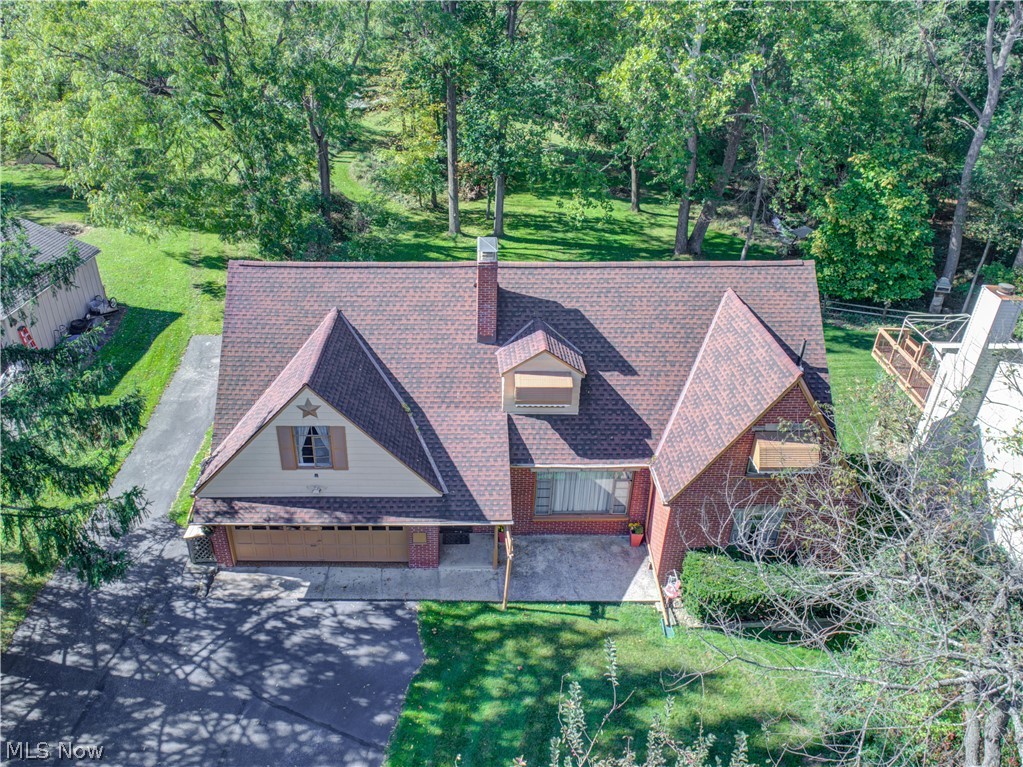 This is the PERFECT North Royalton home for today's buyer who needs 4 garage spaces (2 car attached and 2 car detached), storage, RV/Boat pad, gorgeous deck and walk-out basement to patio area, fire pit, wooded area with small trail & creek ALL on a beautiful piece of land just under 2 acres in the city!  Public water/Public sewer! The best part is...this home can absolutely be used as a "Single Family" home with an upstairs in-law suite (living room, office nook, bedroom, full kitchen and full bath) -or- because it's zoned a "Double" with two electrical meters, you can have rental income if you choose!  Friends, extended family or company?  No problem, you've got it covered! Lots of ways to love the extra space! This unique Cape Cod has a total of 5 Bedrooms and 3 Full baths with over 2600 sq feet of finished living space.  The main floor has 3bdrm/1 bath, The upstairs (in-law suite or rental space) has 1 bdrm/1bath and the walk-out basement has 1 bdrm/1 bath with a cozy fireplace liv