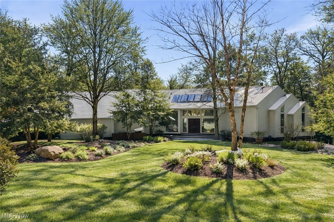 Tucked away at the end of a peaceful cul-de-sac, this extraordinary custom-built contemporary offers a rare blend of refined design, effortless comfort, and truly spectacular panoramic views that unfold both inside and out. A sweeping horseshoe driveway leads to an impressive front entry with oversized double wood doors, creating a striking first impression. Inside, the home is defined by an airy open layout that seamlessly connects the dining area, inviting sitting space, and a dramatic living room featuring soaring ceilings, a statement fireplace, and rich wood-paneled ceiling detail. The dining room is perfectly positioned to overlook the screened three-season porch, ideal for enjoying tranquil mornings or evening gatherings surrounded by nature. The light-filled kitchen is a standout, complete with skylights, an eat-in area, and expansive windows that frame the stunning exterior landscape. The first-floor owner’s suite is a private sanctuary with its own deck, a cozy wood burning fireplace, and a spacious spa-inspired bath with a soaking tub. Upstairs, three well-proportioned bedrooms and two full baths include a serene en-suite retreat and a beautifully appointed Jack-and-Jill bath. The walkout lower level adds flexible living space with areas designed for entertaining and wellness. Set on over 2.6 acres, the grounds are a true escape, with a sparkling Gunnite pool overlooking unforgettable vistas. Bonus tennis court that sits atop the grounds in a private, secluded area. An exceptional property where every season feels like a getaway. Schedule your private showing today.