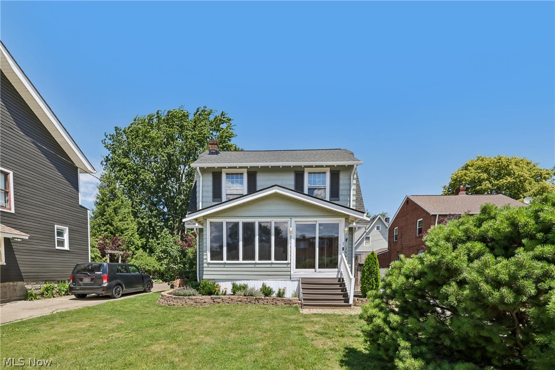 14606 Bartter Ave is a 2-story Cleveland single-family home with a sunroom addition and a rear deck overlooking a fully fenced backyard. The kitchen features white cabinetry, a tile backsplash, dark countertops, stainless steel appliances including a refrigerator, range, microwave, and dishwasher, a center island, and tile flooring with French doors to the backyard. The main living area has hardwood floors and a brick fireplace. The full bathroom includes a tile-surround tub and shower combination with a single vanity. Multiple bedrooms offer hardwood floors with generous closet space. A finished basement provides additional living space, and a sunroom with a wood-paneled ceiling and large windows offers year-round views of the yard. A detached garage completes this Cleveland residence.. Included 100-Day Home Warranty with buyer activation