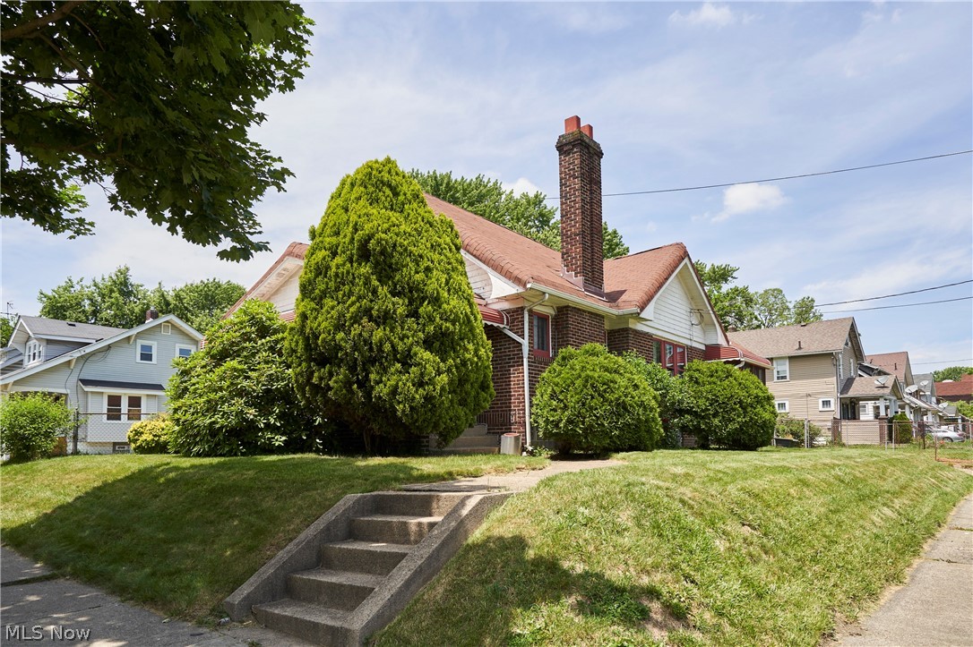 Surprisingly spacious 4BR 2BA brick bungalow on a corner lot in East Akron! Featuring 1st floor living with 2 bedrooms and 1 full bath on each floor (main and 2nd), eat-in kitchen, dining room, living room w/ fireplace & built-ins, enclosed front porch, hardwood under much of the carpet, 2-car attached garage, and a fenced in yard. Conveniently located less than 1 mile from I-77/I-76 & Rt. 8.