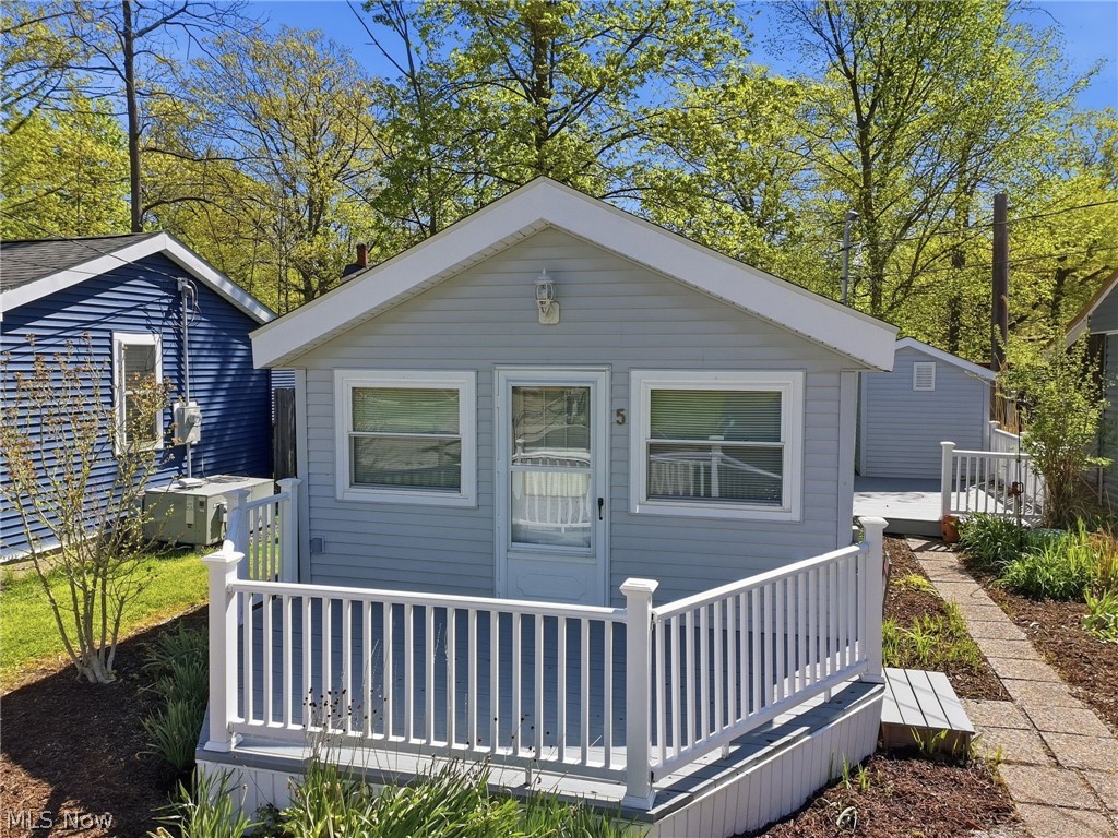 It's the perfect time to enjoy your very own cabin on the lake with private beach access right up the street! The best part is this two bedroom tiny home is able to be lived in all year long! Cute as can be, the cabin has an open concept with a larger living area, a fully functioning kitchen, bath with a large shower, nice sized bedroom and a loft above that is set up as a second bedroom. Located just before the gate, this cabin is part of the Olive Drive Association and is being sold as the cabin only.  The land is owned by the association. Amenities include a large pavilion with kitchen and bathroom and a paved path to your very own beach! Newer windows, roof, flooring, hot water heater, toilet and bath. This is a must see if your looking for a lake get-away! Hope to see you soon!