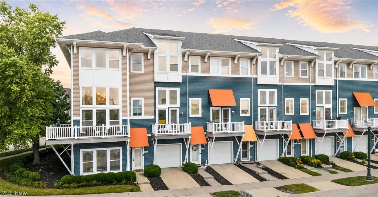 Nestled in the desirable Harbor Walk waterfront community, this exceptional corner townhome offers an incredible lifestyle with scenic views of the Black River and marina. Relax on your private balconies, enjoy breathtaking sunsets, and take advantage of boating, waterfront walking paths, the Lorain Harbor Lighthouse, and the Mile-Long Pier. With multiple outdoor living spaces and beautiful water views, this home perfectly blends comfort, style, and location. Step inside to a spacious, light-filled floor plan designed for everyday living and entertaining. The entry level features a generous family room, while a nearby half bath adds convenience. The main living area showcases dramatic floor-to-ceiling windows framing river views, a beautiful gas fireplace, and access to a wraparound deck—perfect for relaxing by the water. The open-concept third level is ideal for entertaining, offering a spacious dining area and a beautifully appointed kitchen with warm custom cabinetry, granite countertops, a large center island with breakfast bar, built-in buffet with wine storage, stainless steel appliances, and access to a private rear deck. A half bath completes this level. The fourth level is dedicated to the private sleeping quarters. The spacious owner's suite is a peaceful retreat, featuring expansive windows that fill the room with natural light, a comfortable sitting area, and a luxurious ensuite bath. Elegant framed mirrors and designer pendant lighting accent the dual-sink vanity, while an oversized jetted soaking tub, separate glass-enclosed tiled shower, and generous space create the perfect place to unwind. Two additional bedrooms, a full bath, and a convenient laundry room complete the level. Additional highlights include an attached two-car garage and an unbeatable waterfront location. Don't miss this opportunity to enjoy riverfront living at its finest—schedule your private showing today!