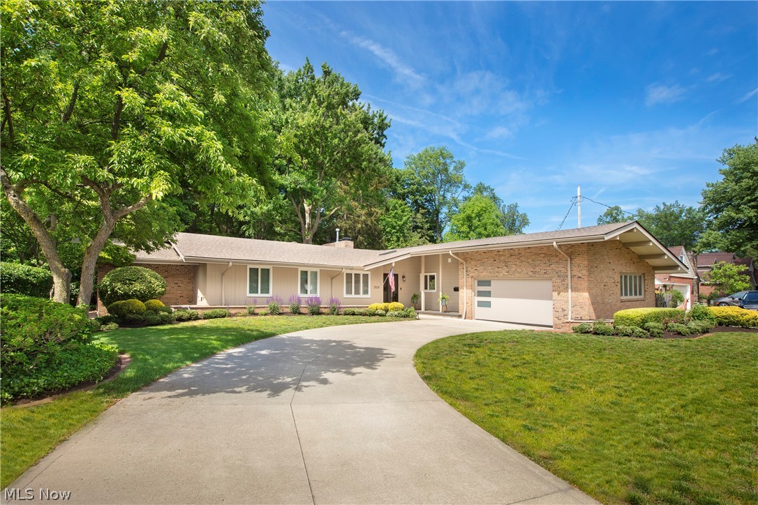 Stunning Mid-century Modern ranch on the most private 2/3 acre in Beach Cliff II. This open living space has been completely remodeled! The chef's kitchen is spacious & well appointed. Enjoy the KitchenAid appliance suite, bamboo floors, and quartz countertops. Extensive counter space to prep & entertain. The Great room offers volume, beamed ceilings with a wood burning fireplace.  The wall of windows lets nature into your home. Enjoy the 1st floor home office with skylight and fireplace--not at all like your brick and mortar office! Added peace in the sunroom to relax with a book and coffee.  Enjoy deer, fox, and birds (including a neighborhood owl). The first floor laundry offers excellent convenience & storage. The Walk-out lower level provides a wonderful space to entertain family & friends. Excellent location to Elmwood Park, Lake and schools. List of extensive updates in attachments.