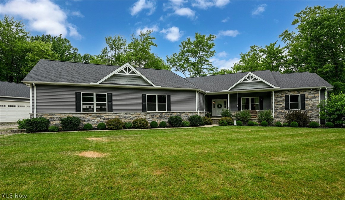 A rare opportunity of a peaceful retreat nestled on 7.6 of beautifully wooded acres adjoining 50+ sq miles of breathtaking Cuyahoga Valley Natl Park offering a true connection with nature. Steps off your backyard follow a creek all the way to the scenic Blue Hen Falls. A tree-lined drive to this private sanctuary welcomes you home, enhanced by electric-serviced posts for landscape lighting or seasonal décor.  This open-concept ranch combines modern comfort, thoughtful design, and quality craftsmanship. A stunning gourmet kitchen features custom cabinetry designed to maximize space, elegant granite countertops, and an expansive breakfast bar for casual dining. The spacious great room is anchored by a stone-faced fireplace with blower system providing warmth and energy efficiency. The home’s impressive amenities continue including: Whole-house Generac generator and a robust 300-amp electrical service for peace of mind. Three-car attached garage with a built-in kitchen - the perfect flex space for hobbies, or outdoor gatherings. Additional heated six-car detached garage with workshop and dog run providing a secure space for four-legged family members. Dedicated greenhouse for gardening enthusiasts. Efficient tankless hot water.  Advanced water softening and AprilAire cleaning systems integrated with the furnace for improved comfort. The fully enclosed, screened porch is a favorite tranquil retreat overlooking surrounding parkland—an ideal place to enjoy morning coffee, evening sunsets, or the sounds of nature. The walk-out basement is exceptional potential with finished walls, marbled concrete floors, abundant light from numerous doors and windows, and plumbing for another bath. This lower level is ready to be transformed to fit your lifestyle. A rare blend of privacy, modern amenities, and direct access to one of Ohio’s most treasured natural landscapes—this property offers the peaceful lifestyle of a park retreat while keeping today’s conveniences right at home.