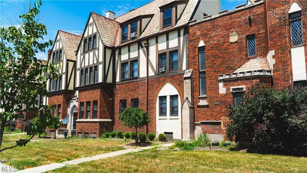 Exceptional Investment Opportunity — This impressive 22-unit apartment building showcases classic Tudor-style architecture in a highly desirable historic district.  Rich in character, the exterior highlights a brick facade with intricate stone detailing, offering timeless curb appeal and modern functionality.  Inside, residents enjoy updated units featuring hardwood floors, wrought iron accents, cathedral ceilings, and contemporary kitchens with custom cabinetry, granite countertops, and stainless-steel appliances. The building also offers a convenient lower-level laundry facility and secure on-site parking with a private garage.  The property is lead-certified with the City of Cleveland and comes with the added advantage of ongoing professional property management through Century 21 Wilbur Realty.  A first-year introductory rate is available, providing a smooth transition for new ownership.  With its prime location, historic charm, modern upgrades, and built-in management support, this beautifully maintained apartment building presents a compelling opportunity for investors seeking both stability and long-term value.