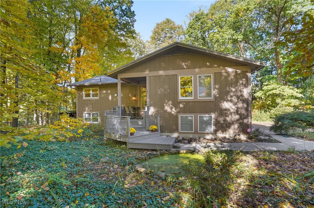This home is nestled in the woods, offering a serene and private setting surrounded by nature. As you approach, you're greeted by a rustic exterior that blends charm with Mudd Brook creek running behind the property, adding to its tranquility.  It is so peaceful listening to the running water in the creek in the ravine.  Inside, the great room is the heart of the home. It features a large wood-burning fireplace made of stone with a rustic mantel perfect for cozy evenings. A beautiful array of windows overlook the woods, allowing for an abundance of light and and offering stunning views of the surrounding greenery and wildlife.  The eat-in kitchen  features a breakfast bar and two eating spaces so there's plenty of room for gatherings and entertaining.  The primary bedroom offers three closets and full updated bath with double vanity and walk in shower.  The other two bedrooms have ample closet space and the second full bath has also been updated.  The lower level offers a bedroom, which could also be used as an office, with a living area/recreation room with access to the screened in porch.  Roof and 2 full baths updated - 2021.  Home Warranty is being provided by the seller.  Gas mineral rights do convey with the property. Hot water tank - 2024 with 6 year warranty provided.