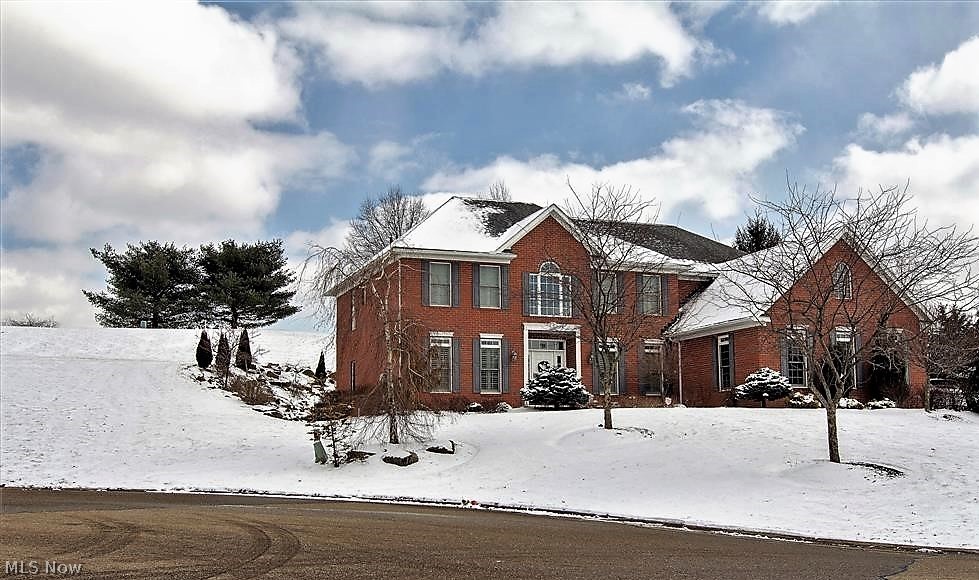 Situated in the prestigious Glenmoor Country Club gated community, this all brick architectural delight was built in 2007 -  w/over 5300sq ft finished space and is perfectly tucked away in a cul de sac on over ½ acre lot with a huge private backyard. The marvelous interior further captivates with three levels of comfort and style touched with essential top notch fixtures and fittings throughout! An elegant two story foyer opens to the formal living and dining rms- study/1st floor guest bedroom/closets & private door to luxury bathroom. Soaring GR with abundance of light leads via column accents to: sunroom w/dr to patio- gourmet kitchen w/eating bar- complementary appliances and dinette- nicely tucked away is the laundry. The 2nd floor by way of two staircases houses the owners suite truly unique with arches –stone pillars and separate lounge to private elevated deck – Oh, and an awesome view of the golf course – the ensuite bath further impresses with a new top of the line shower- cor