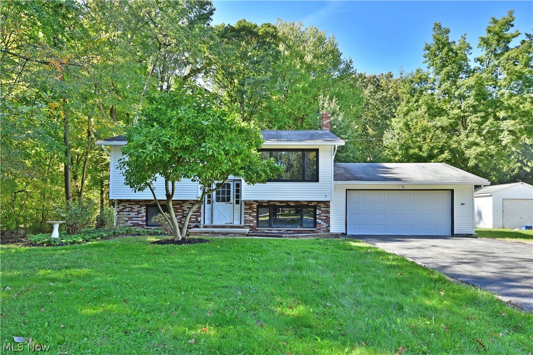 With its prime location and spacious, move-in-ready living space, you won’t want to miss this fantastic four-bedroom Howland Township bi-level! Find yourself in the heart of it all as a beautiful park is just a brisk walk away along with desirable locale restaurants and attractions. Tall trees surround the residence as its partial brick façade creates plenty of curb appeal, outlining the large windows and clean white siding and attached two car garage. A brightly lit, tiled foyer besets a carpeted staircase leading to the main floor. Here a spacious living room takes full advantage of the picture windows, as the sunshine fills the nearby dining room. A corner kitchen is dressed in a faux brick backsplash with warm wooden cabinets that break up the bright white appliances. Around the corner, a fantastic, finished sunroom overlooks the scenic backyard. Opposite, the main hall sweeps past a lovely full bath with glass block accent work as a pair of inviting bedrooms are found at the end o