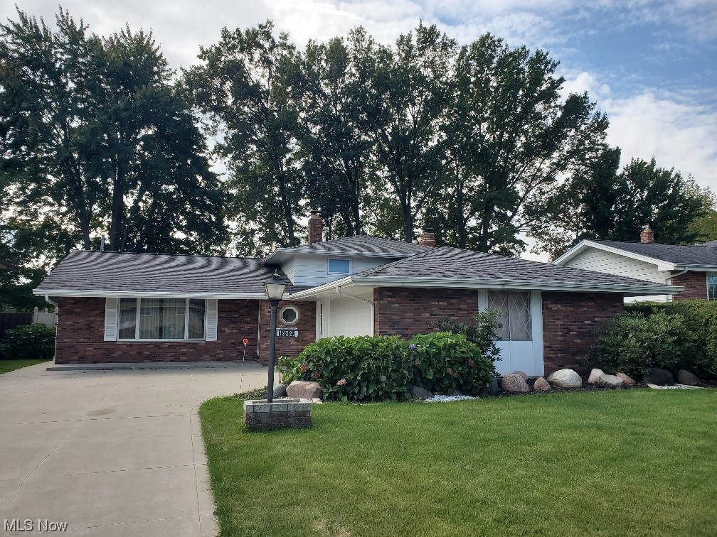 This impeccably maintained family home has been lovingly cared for over 4 decades! Step inside this inviting brick, aluminum split level residence and discover its array of wonderful features. The heart of the home is the custom designed eat-in kitchen, featuring stainless appliances including a gas stove, refrigerator and dishwasher. The tiled living area is spacious with high ceilings that create an open and airy atmosphere. Adjacent you will find a formal dining to entertain with doors leading to the patio. A perfect setting for entertaining and family. With 3 generously sized bedrooms, each boasting ample double closets and beautiful hard wood floors, this ensures that everyone has their own space to retreat to. Upstairs you will find a fully updated bathroom, while the lower level offers a convenient half bath for added convenience. The family room is cozy and practical with a welcoming full stone wall fireplace with insert/woodburner. It opens to a fenced yard, offering a seamless transition between indoor and outdoor living spaces. In addition, the conveniently located laundry room off the family room connects to a two-car attached garage complete with water and electric. Outside the home is a delight with a variety of perennials. This home is ready to welcome you into a warm and inviting embrace!