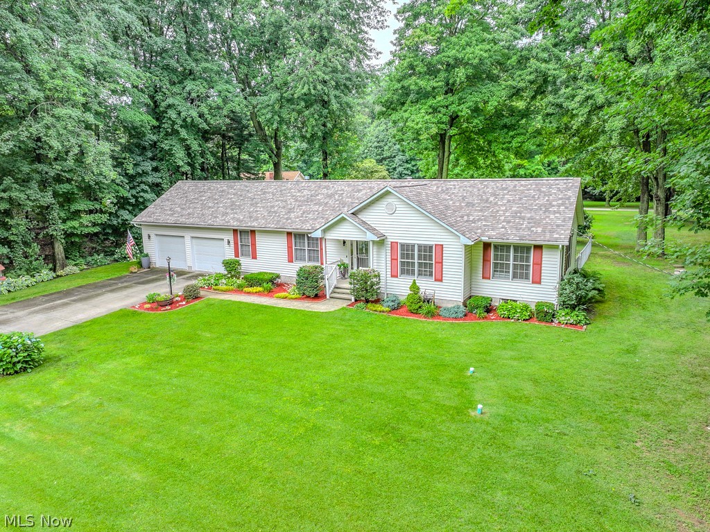 Welcome to 1966 Spring Grove, where the craftsmanship of a talented carpenter meets the eye of a gifted designer. Tucked away on a quiet dead-end street with Lake Erie views from the side yard, and just steps from Stanton Park and Rabbit Run Theater, this home offers a lifestyle that's every bit as impressive as the renovation itself.

Designed with today's empty nesters in mind, nearly every space has been thoughtfully reinvented. The stunning new kitchen opens beautifully into the vaulted great room, while two completely renovated baths, first-floor laundry and an expanded flex room create the ease of true one-floor living. Need a third bedroom? It can easily be converted back.

The list of improvements continues with a new roof (2025), septic system (2019), Trex deck and railings, and more than 1,000 square feet of beautifully finished lower-level living space that's ready for movie nights, game days or visiting family.

Storage lovers will appreciate the hidden bonus room off the garage leading to a floored attic spanning much of the home—a feature you simply don't find every day. Garage is heated and oversized at 27' x 24' for extra storage opportunities.

Located on Madison's western edge, you'll enjoy a shorter commute toward Cleveland while still coming home to peaceful surroundings, mature trees and glimpses of Lake Erie.

Move-in ready doesn't begin to describe it. This is the kind of home that rarely becomes available...and once you walk through it, you'll understand why.