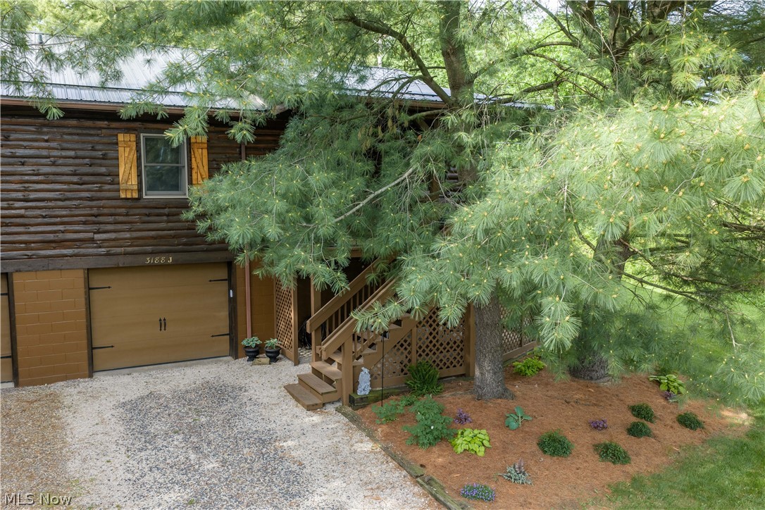 Tucked among the trees in a desirable  community, just minutes from I-77, this beautifully remodeled log cabin style condo offers the perfect blend of rustic charm and modern updates. Upon arrival, the peaceful setting feels like your own private treehouse retreat, surrounded by nature and serenity. Inside, you'll find thoughtful upgrades throughout including granite countertops, stainless steel appliances and LVP flooring creating a warm and functional space. The inviting interior captures the cozy character of a cabin while offering the comfort and convenience of updated living. Furnace/AC and roof new in 2023. Well pressure tank, overhead garage opener in 2026. Beyond the home itself, residents appreciate the attentive and responsive HOA which makes this a truly wonderful place to live! This property offers a lifestyle that feels like a getaway everyday! 245 monthly condo fees, shared well/septic are associations responsibility.