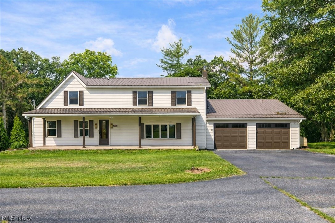 Nestled on 1.73 acres, this stunningly renovated 4-bedroom, 2-bath home offers 2,400 sq. ft. of beautifully finished living space designed for both comfort and style. Step into the grand foyer, complete with a custom built-in bench—perfect for keeping everyday essentials neat and organized. The main level is made for living and entertaining: a spacious living room with new Beasley hardwood flooring throughout, a formal dining room for unforgettable gatherings, and a large family room with plush carpet that invites cozy movie nights or lively celebrations. The showpiece kitchen is a chef’s dream, featuring custom cabinetry by Sealock Woodworking, quartz countertops, a stainless-steel farm sink, and brand-new stainless-steel appliances. A convenient main-floor bedroom and updated full bath add flexibility for guests or multi-generational living. Upstairs, the luxurious primary suite feels like a private retreat, complete with a spa-inspired bath boasting a double-sink vanity, walk-in shower, and elegant ceramic tile flooring. Two additional bedrooms and dual staircases add character and convenience. Outdoor living is just as impressive: enjoy morning coffee on the sprawling covered front porch, host summer barbecues on the tiered back deck, or explore the expansive yard with storage shed. The attached garage easily accommodates two or more vehicles, and the metal roof (2020) provides lasting peace of mind. With extensive renovations throughout, this home blends timeless charm with modern upgrades—turnkey, full of character, and ready for its next owner to fall in love.