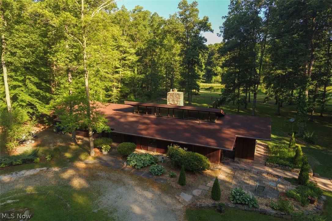 Custom built, waterfront home is ready for your lifetime of fun and enjoyment. Welcome home to 36 picturesque acres of paradise including a fantastic, fully stocked pond with floating dock! Architect Gerald Rembowski, known for Frank Lloyd Wright style homes, designed this beautiful Redwood sided, 4 bedroom, 2 1/2 bathroom ranch, contemporary home with soaring ceilings, gorgeous stone fireplace, and abundant views of the lake and woods from every direction!  Enjoy scenic trails thru the woods containing numerous mature Oak, Hickory, Maple & Beech trees! Detached 2+ car garage with heated office or extra storage area! Fenced in area behind is perfect for pets or children! Large 13x26 deck and quaint patio too! Huge temperature controlled outbuilding with bathroom is perfect for your home based business or for the savvy collector! Super cute heated & cooled granary building too with root cellar and wood burning stove could make the perfect area for classes, crafts and endless possibiliti