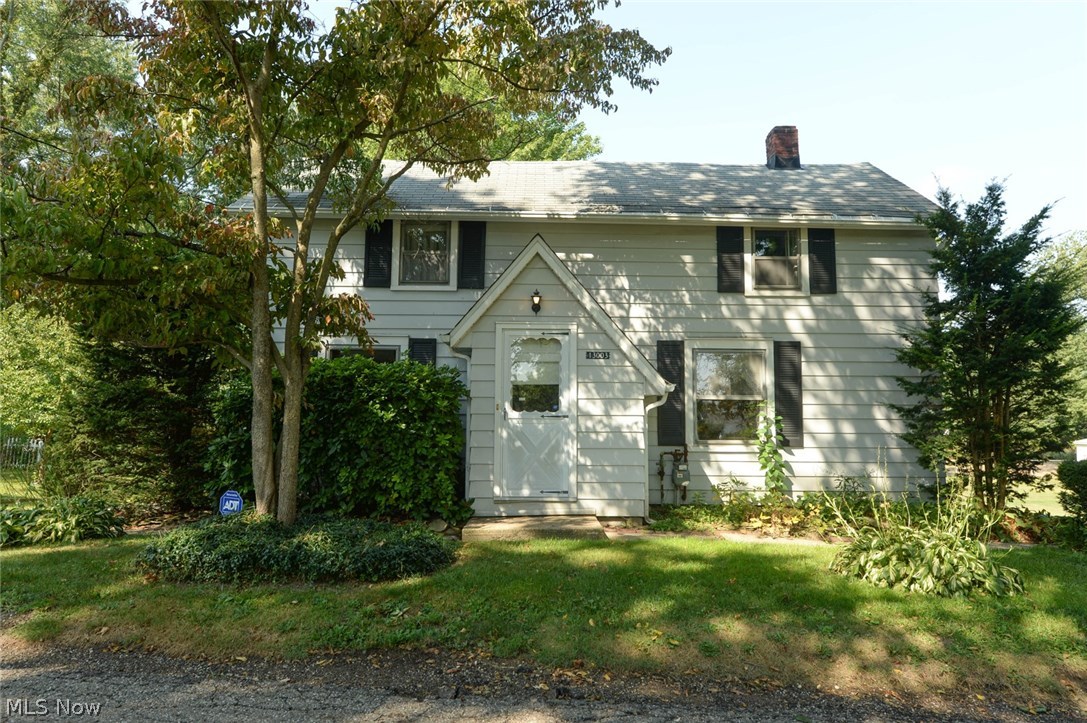A Lake Township steal!  This home has 3 bedrooms, 2.5 bathrooms, a finished basement with bonus room, rec room and a kitchen all on 2 lots!  Main floor kitchen includes range, refrigerator, dishwasher, charming spice pantry and unique cabinets.  There is a large bedroom, full bath and big linen closet on the first floor.  Full dining room with an adorable light fixture and large living room with built in book shelves, front entry way and coat closet.  Original hardwood floors under first floor carpets.  Head upstairs to the remaining adjoining bedrooms and half bathroom.  Downstairs there's more space for family time, a great man cave or an apartment space.  There are 2 finished rooms, a full bathroom, kitchen with laundry area, a storage room and tons of hidden closets and shelving.  Out back is the brick patio that leads to the awesome enclosed patio room.  This room is built out of beautiful old beams, has a ceiling fan and a wet bar.  The landscaping creates lots of charming nooks