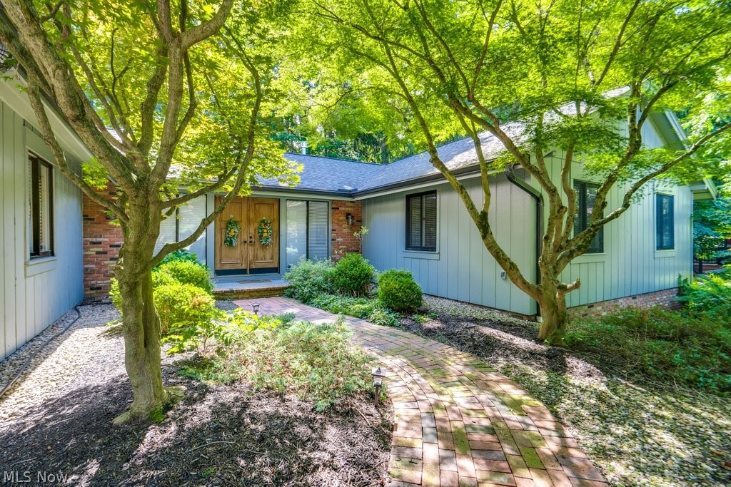 Tucked away at the end of a quiet cul-de-sac, this beautifully renovated mid-century modern ranch offers exceptional privacy and breathtaking views, backing directly to the northern rim of the Cuyahoga Valley National Park. With six bedrooms and three-and-a-half bathrooms, including four bedrooms and two-and-a-half baths on the main level plus two additional bedrooms, a kitchenette, and a full bath in the walk-out lower level, this home offers exceptional flexibility for everyday living, entertaining, or multigenerational needs.

Designed to embrace its natural surroundings, expansive windows and multiple sliding glass doors fill the home with natural light while showcasing the wooded backdrop. The stunning 26' x 14' kitchen, renovated in 2023, features two sinks, acrylic countertops, abundant cabinetry, a spacious pantry, and an 8-foot sliding glass door opening to an impressive outdoor kitchen. The formal dining room connects to the dramatic vaulted living room, where a floor-to-ceiling stone gas fireplace creates a warm focal point. Step onto the expansive deck with cable railings and enjoy peaceful forest views.

The spacious primary suite offers private deck access, large windows overlooking the park, and a generous en-suite bathroom.

Recent updates include a new roof, skylights, hardwood flooring, kitchen and bathroom renovations (2024), Renewal by Andersen sliding glass doors (2024), fresh interior paint, a new hot water tank, exterior paint, and new gutters (2025). An attached two-car garage and abundant storage complete the home.

Located in the highly desirable Greenwood Village community, residents enjoy a clubhouse, indoor and outdoor pools, sauna, fishing lake, tennis courts, playground, and convenient access to Cuyahoga Valley National Park, scenic hiking trails, and the Bike & Hike Trail.