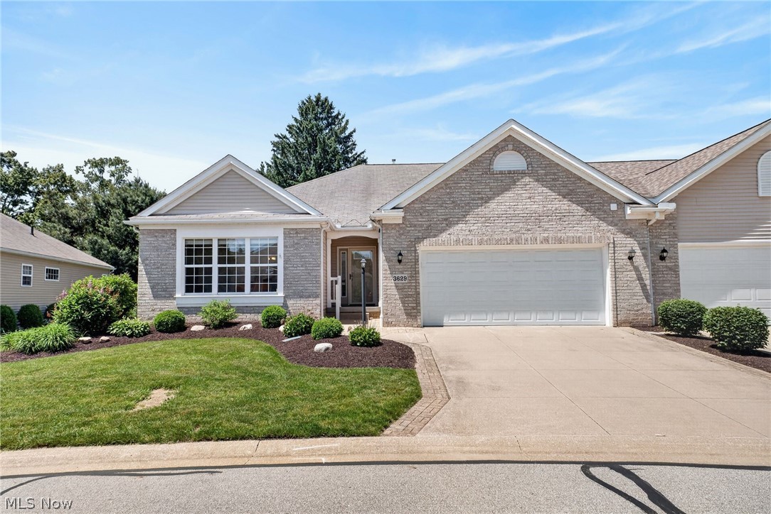Welcome to Stratford Green, where your dream of luxurious, low-maintenance living comes to life! This stunning Tuscany model home spans over 2,200 square feet with peaceful views of the golf course and close proximity to the clubhouse at Mayfair Country Club. As you enter the home, you’ll be impressed by the open-concept design that flows effortlessly through the living, dining, and kitchen spaces. The large kitchen is a chef's dream featuring soaring vaulted ceilings, a ton of painted custom glazed wood cabinetry, pull-out drawers, and a large center island with built-in microwave. The raised bar sitting area is ideal for casual meals or entertaining guests. The sunroom is an extra space to relax, have morning coffee, read, or hangout with friends and family with light pouring in through windows and custom made stained glass transoms. Retreat to the master suite, accentuated by vaulted ceilings and a calming atmosphere. The spacious master bath and closet features a large closet space, new shower with glass door, and soaking tub with tile surround. Two additional generous bedrooms with sizable closet spaces provide versatile options for guest rooms, home offices, or hobby spaces. Natural light pours in through large windows, enhanced by elegant transoms, while a cozy gas fireplace warms the living area, perfect for relaxing evenings. The exterior of the home features a private paver patio with retractable awning for shade. The front porch features new composite railing, storm door, and a heated roof ice melting system. The upgraded extra wide driveway features decorative paver stones for great curb appeal! Additional features such as vaulted ceilings, a spacious laundry room with storage, a yard irrigation system, and extra garage space enhance the overall appeal. Nestled in the coveted Stratford Green community, this remarkable home offers an unforgettable lifestyle. Schedule your private showing today and imagine living in this meticulously-maintained residence!