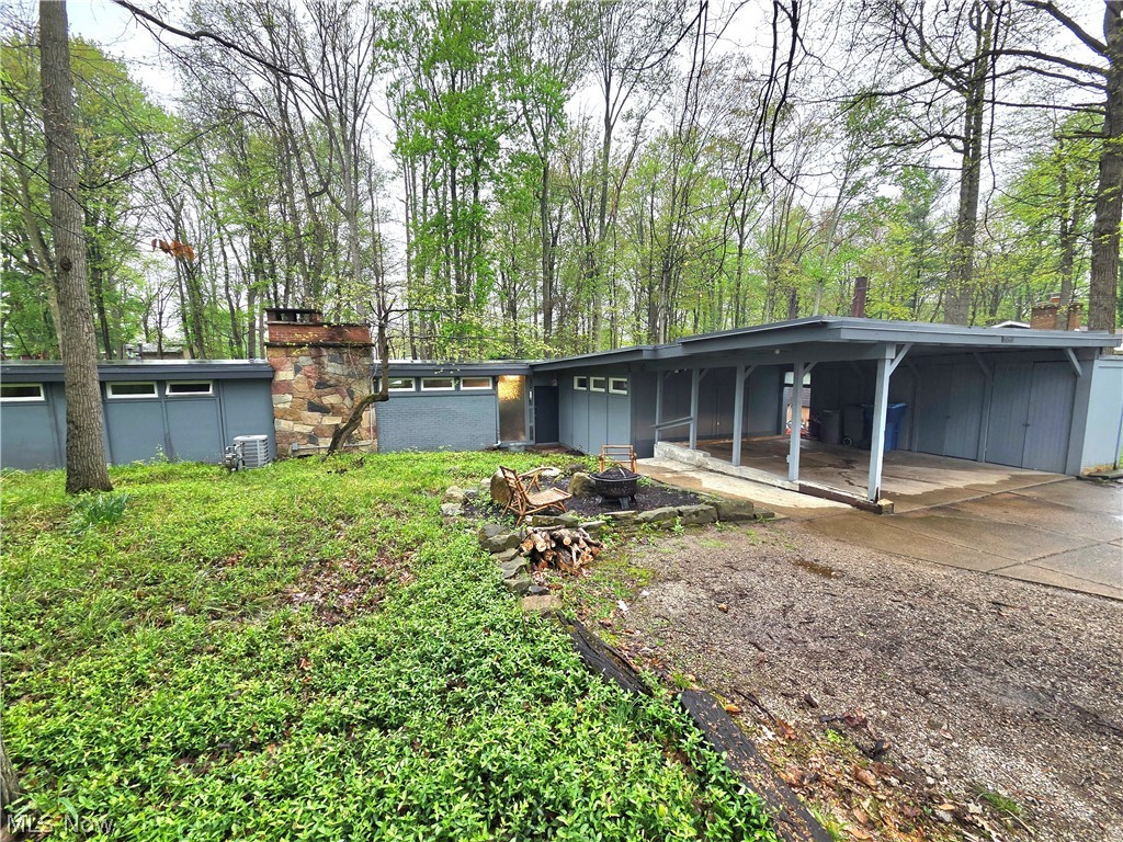 PRICE JUST REDUCED!! Welcome home to this architecturally stunning 3-bedroom, 2-bathroom Frank Lloyd Wright-inspired ranch, nestled on nearly an acre of private, wooded tranquility. This 1,853 sq. ft. masterpiece boasts an expansive open floor plan centered around a chef’s kitchen featuring granite countertops, a center island with cooktop, and a charming coffee/wine bar with butcher block counters and a secondary sink. The living room features a beautiful wood burning fireplace and a dramatic wall of windows invites nature indoors, leading to a private patio and serene backyard perfectly suited for relaxation. Side yard with large shed gives more room to play and entertain! Extensive high-end updates ensure total peace of mind, including a brand-new hot water tank (2026), Pella windows (2023), plush new carpet (2023), and a furnace and central air system (2022). The master suite highlights unique wood ceilings and abundant light, while the oversized 2-car carport offers versatile space for a potential office or workshop. Perfectly situated for an active lifestyle, you are just steps from the Cleveland Metroparks and the Chalet, while Southpark Mall and endless shopping and dining options are conveniently located within a mile. Experience a secluded, country feel just minutes from Cleveland Hopkins Airport and the vibrant energy of Downtown Cleveland. This exceptional home is complete with a one-year America's Preferred Home Warranty for the buyer’s added confidence.