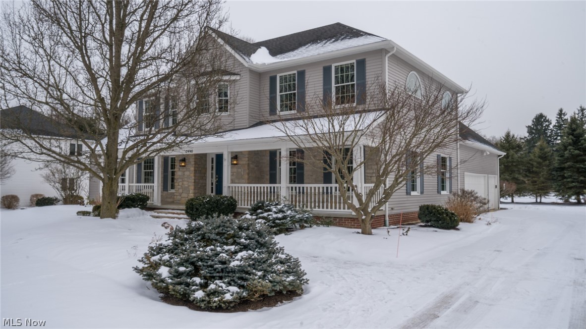 Located in Emerald Woods, just a stone's throw from Cuyahoga Valley National Park.  As you pull up, it is immediately inviting with its sweeping front porch, stone facade and impeccably landscaped yard. 4 bedroom 3.5 BA colonial just painted on the main floors. Upon entering, you'll instantly feel the simple sophistication, and charm of a New England style home.  Beautifully stained hardwood floors adorn the foyer, dining and kitchen. Relax and watch your favorite TV show or movie with warm drink by the gas fireplace with vaulted family room ceiling. Sit a spell in any room and enjoy the natural light or during the spring and summer months open the slider doors by the kitchen eating area and step outside with a cold beverage and enjoy yourself on the stone patio. The kitchen has a large granite island with granite counters and new stainless steel appliances. First floor laundry and updated 1/2 bath and office/den are just off of the kitchen. Sizable bedrooms with new carpet by a common