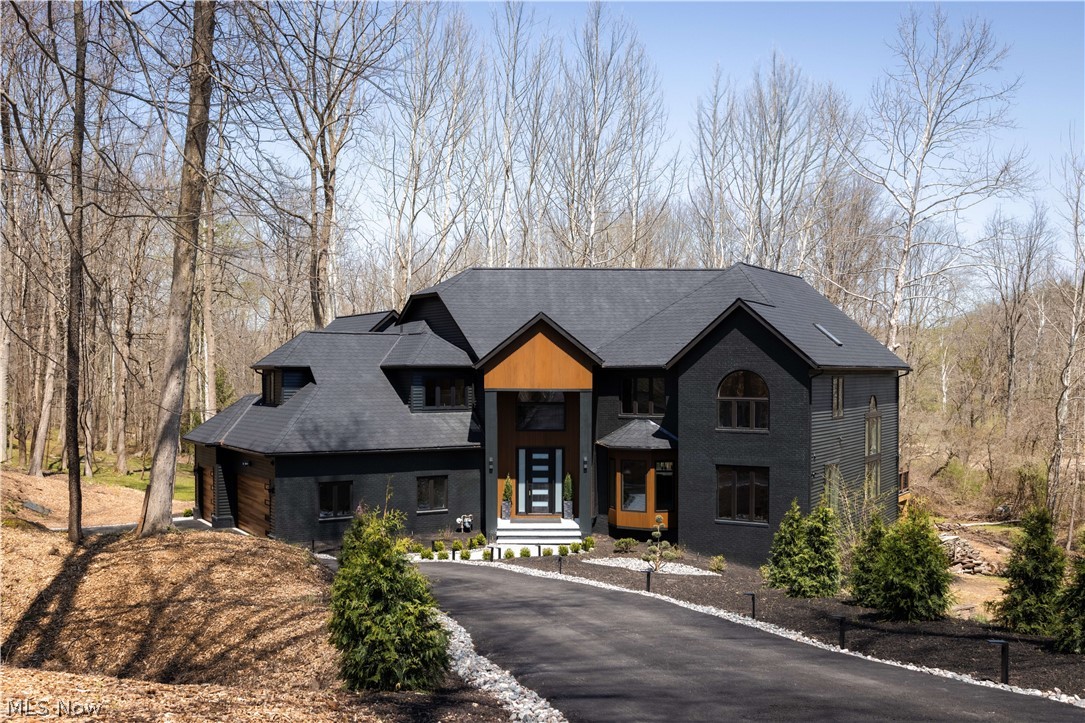 Rare opportunity to own a fully renovated luxury modern home in one of Solon’s most desirable areas, the prestigious Chagrin Highlands community, located within the top-rated Solon School District. This exceptional residence features 6 bedrooms and 5 full bathrooms with high-end finishes and custom design throughout. Den/Office on the first floor could also be the 7th bedroom.  The main level showcases a stunning open-concept layout with soaring 20+ ft ceilings, a dramatic floor-to-ceiling gas fireplace, and oversized picture windows filling the home with natural light. The designer kitchen is a true centerpiece, featuring custom cabinetry, a massive 22-ft quartz waterfall island, high-end appliances including a 48” ZLINE range, smart refrigerator, double farmhouse sinks, beverage fridge, and built-in pop-up outlets with charging stations. The home offers a versatile layout with four bedrooms on the second floor, a main-level Den/Office w/closet is ideal for guest suite (7th bedroom), and two additional full bedrooms with closets and large windows in the fully finished walkout basement. The basement provides exceptional living space with windows on three sides, two sliding walkout doors, a full bathroom, stylish wet bar with refrigerator, dishwasher, and sink, plus an electric fireplace. The luxurious primary suite features a private balcony, custom closets, and a spa-inspired bathroom with steam shower, freestanding tub, heated floors, and smart features. Outdoor living is equally impressive with a newly built ~1,500 sq ft composite deck, brand-new stamped concrete patio, professional landscaping, and custom exterior lighting throughout—perfect for entertaining. Seller will install a brand-new roof and replace the majority of siding prior to closing, offering added value and peace of mind. Additional highlights include two laundry areas, designer lighting, and extensive upgrades throughout, making this a true move-in-ready luxury home. See Agent remarks