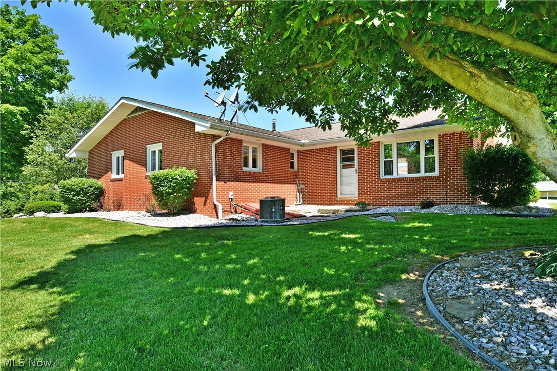 On the hunt for more space in an attractive, move-in-ready package? What about scenic, semi-rural views and that great country feeling while being just minutes from great local attractions and necessities? Take a closer look at this outstanding Cortland residence, offering up space for all your needs and then some! While you won’t want to miss the home, the expansive property is sure to wow with no less than three impressive outbuildings. Garage 65 x 35, Outbuilding 35 x 20, RV/Boat Storage 35 x 30, Shed, Storage, Storage shed/outbuilding. A massive, detached garage and shop space provides tall ceilings and storage or workspace for a variety of vehicles, watercraft and equipment, all with easy, pass-through access. Further back down the winding driveway, a secondary garage brings an extended height door, perfect for shorter recreational vehicles or taller boats, tractors and alike. Thirdly, the deep set and oversized storage building is split into two partitions, each with cement flooring and treated wood walls. The darling home sits centerpiece, beckoning with its multiple covered patio areas and handsome, all-brick construction. Through the front door, a sun washed living room enjoys its large windows and hardwood style flooring that continues down the near hall. The heart of the home is a tastefully updated kitchen with its stone countertops, stainless appliances and hooded range. Eat-in dining joins while a serving window peers into the welcoming rear family room where a tiled fireplace accompanies walk-out patio access. From the kitchen, a pass-through half bath awaits the basement entry, leading into the master bedroom. A pair of additional, spacious bedrooms branch from the wrapping and closet lined hall, each joining a colorfully appointed full bath with its specialty, mobility friendly tub and shower. Down below, laundry service and utilities reside in the full basement, nature stone treated  with an additional storage hall, plus a walk-out stairway.