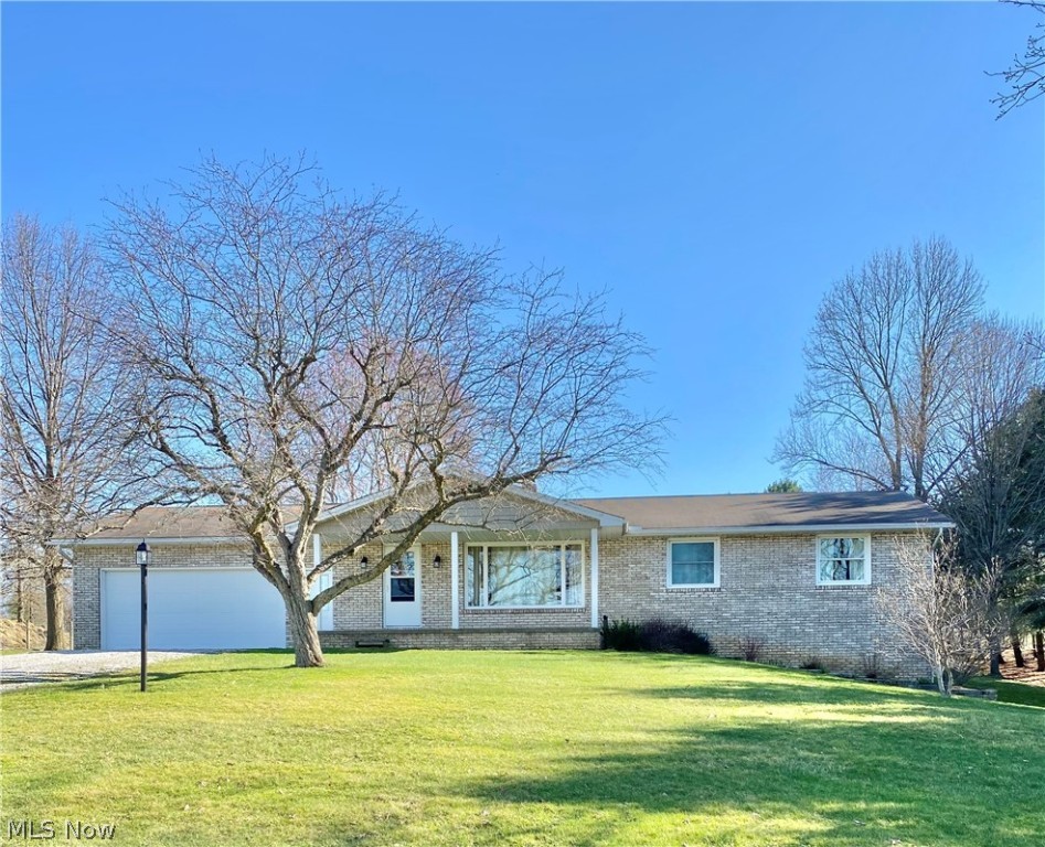 Don't miss the opportunity to own this lovely 3 bedroom 1.5 bath brick ranch situated on 2 acres.  This home features a nicely appointed kitchen with beautiful maple cabinets and  breakfast bar. Refrigerator and stove remain. The  adjacent dining room has a window overlooking the large backyard and has a wonderful built-in maple china cabinet.  The living room is spacious and boasts a huge picture window looking out over the beautiful front yard and fields across the street.  There is a nice sized Master bedroom with plenty of closet space. There are 2 other bedrooms with ample closet space on the main level.  The full bath and half bath have been updated.  The lower level has a large family room with a door that walks out to the side yard.  The lower level also has a bedroom/office with a full daylight window. This home offers tons of storage space and has a 2 car attached garage as well as a 20 x 30 pole barn to the rear of the property all tools and supplies in the barn remain with