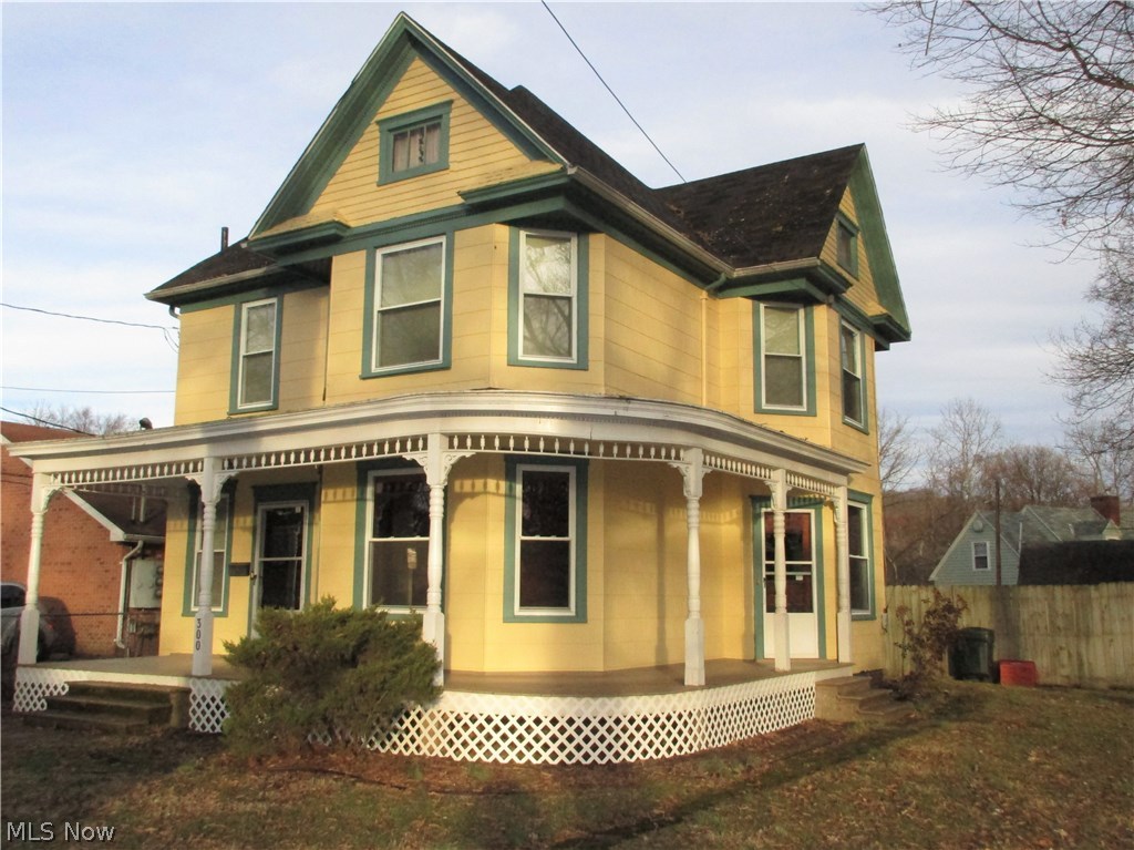 Lovely three bedroom, 2 full bath home in Norwood.  Big wraparound front porch with freshly painted exterior.    Hardwood floors on first floor with original oak woodwork.  Large living room with bay window area offers a tiled decorative fireplace with mirrored oak mantle and built-in bookcase.    The spacious dining room has a built-in hutch, decorative fireplace and side door access to the covered porch.  The updated kitchen has an abundance of lovely hickory cabinets with a new dishwasher.  The convenient first floor laundry and full bath with new vanity have new flooring just installed.  There is rear access to the backyard.  The second floor offers three spacious bedrooms and a full bath with new vanity.   Plaster has been removed with all new drywall installed.   Newer furnace (2010), updated plumbing and wiring.  Big level fenced backyard  and a 1 car garage at the rear are a bonus.  Move-in ready.  This won't last!   M209