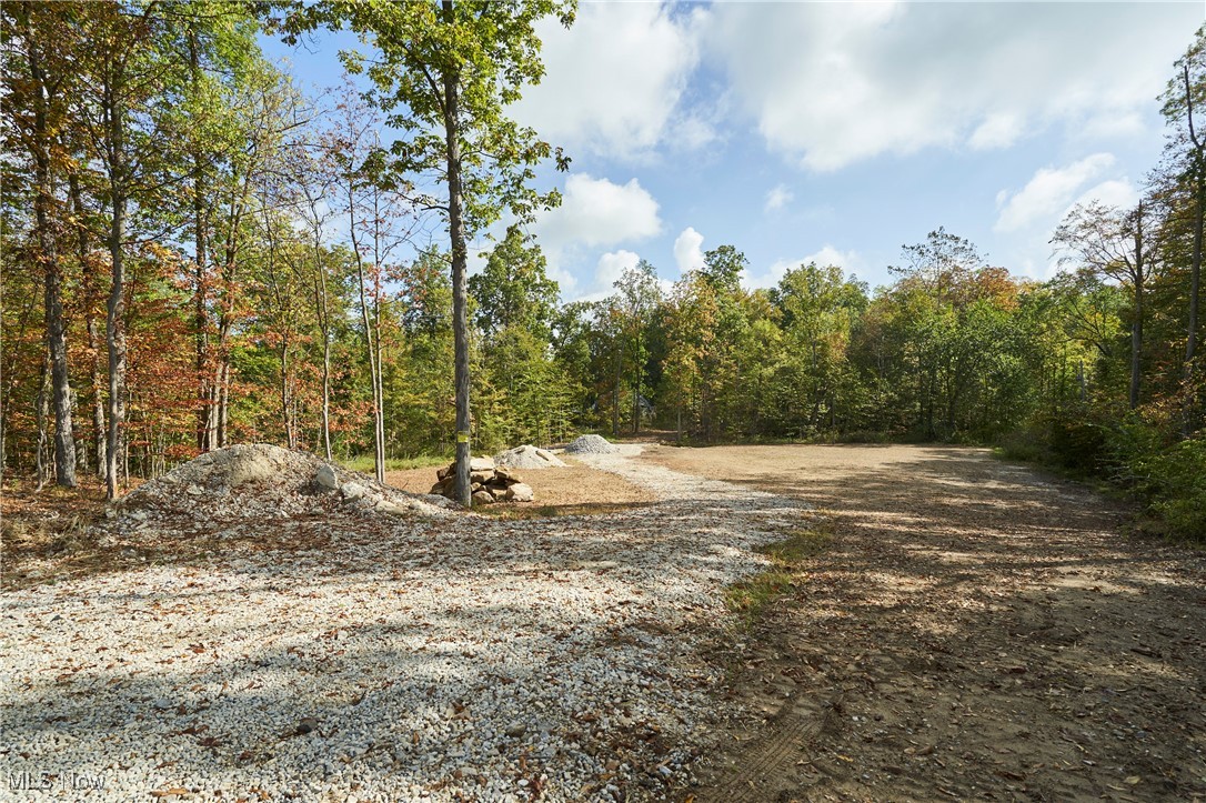 Tucked away in the heart of scenic Sharon Township, this one-of-a-kind vacant lot offers the perfect opportunity to design and build your dream home. Whether you prefer to bring your own builder or take advantage of the seller’s build-to-suit option, this property is ready to make your vision a reality.
The homesite has already been thoughtfully cleared and is nestled deep within the woods, providing unmatched privacy and breathtaking views of the natural landscape. Here, you’ll enjoy the rare combination of seclusion and convenience—an ideal retreat with the freedom to create a home exactly as you’ve imagined.
Sharon Township is one of Medina County’s fastest-growing communities, celebrated for its balance of rural charm and modern amenities. Part of the award-winning Highland School District, the area is sought after for its top-rated education, beautiful landscapes, and strong community atmosphere. Just minutes away, Sharon Center serves as the township’s picturesque hub, featuring a tree-lined park with gazebo, restored historical homes, and a vibrant calendar of community traditions. From summer festivals to evening band concerts, this is a place where neighbors gather and community thrives.
This rare offering is more than just land—it’s an invitation to create your private sanctuary in one of the area’s most desirable locations. Whether you purchase outright or explore the build-to-suit opportunity, the possibilities here are limitless.