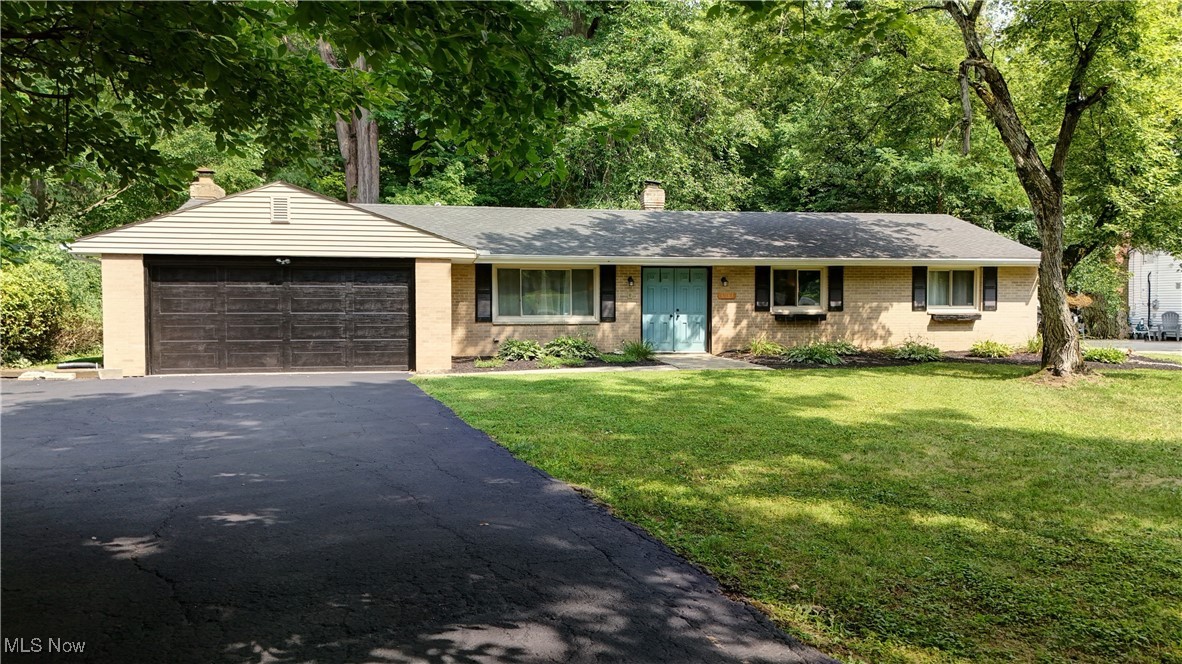 Welcome to this charming ranch-style home located at 8063 Rolling Brook Rd in Sagamore Hills, OH. Nestled on a private lot with a treed back yard that leads you to a private little path leading you to a cozy fire pit. Step inside to discover a spacious interior with three bedrooms and two full baths. The open layout includes a cozy living room with newer luxury vinyl floors, a dining area, and a well-appointed kitchen, perfect for hosting gatherings or enjoying quiet evenings at home. With a two car garage and a lot of updates within the last few years, including a new roof, siding, and gutters, and both bathrooms, this home offers both comfort and peace of mind. Don't miss the opportunity to make this beautiful home yours. Call Brandon to schedule a private showing today !