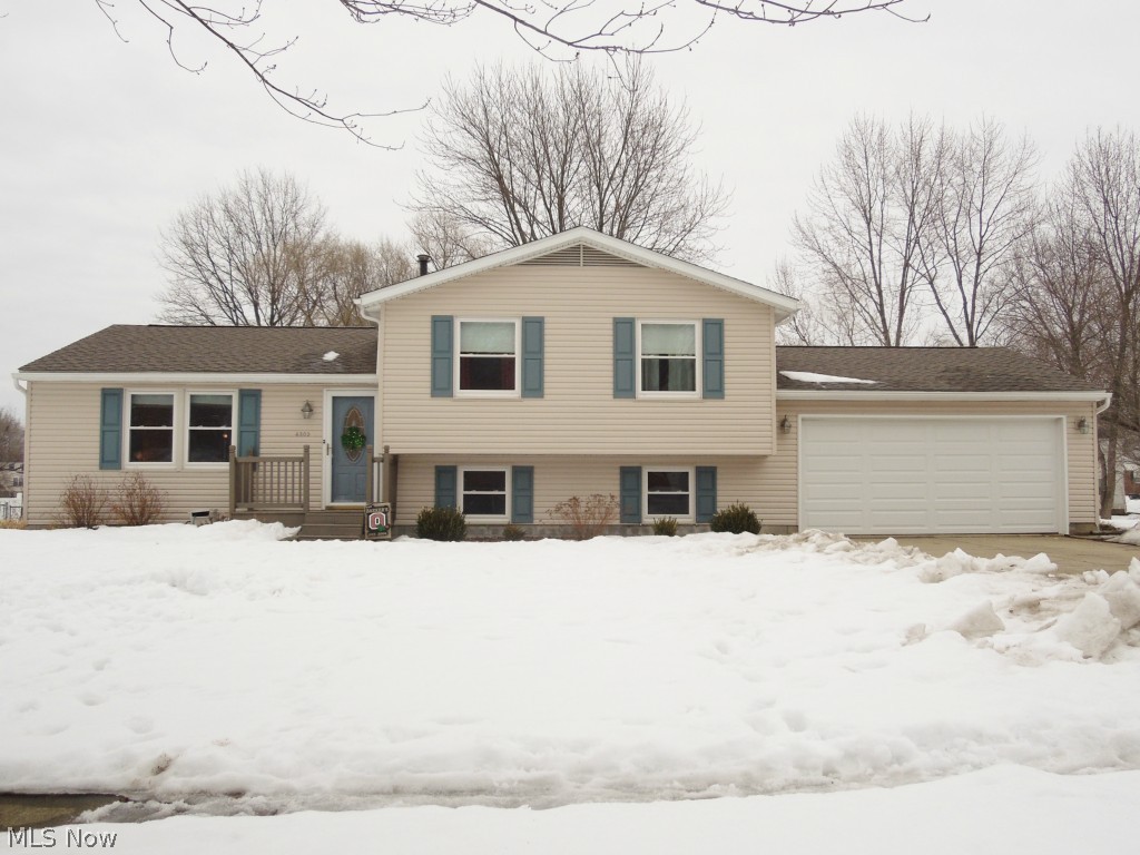 Looking for a MOVE-IN Ready home in a well sought after area? Then this house is a MUST SEE!  From the moment you step foot inside the front door you'll notice the difference.  This three bedroom split level house is meticulously CLEAN and completely UPDATED! Highlights include newer roof (2012), vinyl siding (2012), garage overhead door and header (2012), hot water tank (2006), and windows (2009). The kitchen has been completely updated with new counter-tops, sink, cabinets and disposal in 2014. Newer sliding glass door in the dining room leads to a great deck perfect for entertaining!  Laminate flooring was installed in the kitchen, dining and living room in 2008.  Also, the carpet on the stairs and second floor is newer too (2011)! The front of the house features a newer front porch (2012) and an attached two car garage.  PLUS there's a good size shed in the backyard perfect for storing outdoor yard equipment. HURRY and schedule your private showing --this beauty won't last!