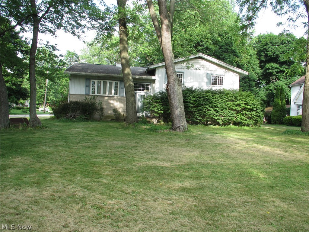 This home is located in the award-winning, Springfield school district and is priced well under market to give you room to personalize it and do the repairs that are needed with cushion.  It is located on a huge, oversized corner lot with not only an attached 1-car garage but also a 3-car detached garage with additional parking area.  A large deck off the back has potential for a great outdoor living area.  The hardwood floors throughout are good.  The main level has an open floor plan with great possibilities!  The home is being sold AS IS with any personal items the seller chooses to leave behind.