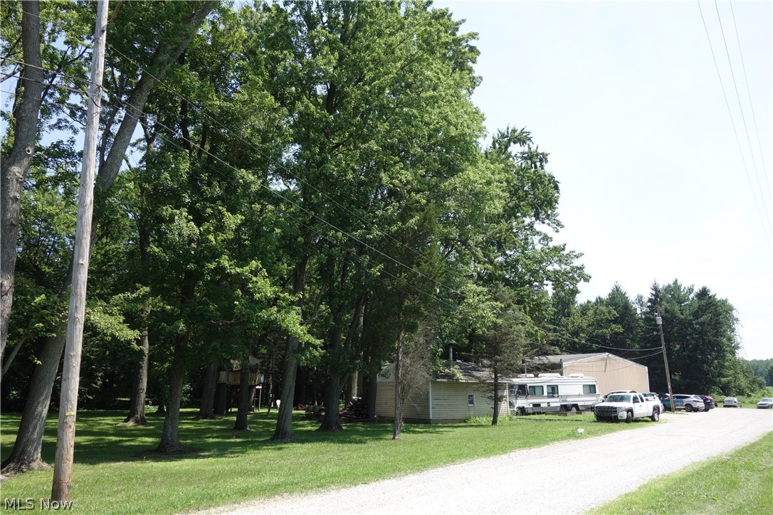 2+ Beautiful & private acres surround this 9,512 sq. ft. building, thoughtfully divided and designed for multiple uses, with a prime location near I-75 West & East Expressway entrance(s) and exit ramps. Currently leased to three long-term tenants on month-to-month agreements, the property has four electric meters and potentially four gas meters, each billed separately. This is an intriguing investment opportunity to generate income or put your personal touch "TLC" on the attached 2-bedroom, 2-bath Attached ranch, while utilizing the full 9,512 sq. ft. for a dream home business. The ranch tenant has been there 12–13 years, paying $500/month plus utilities. An established Automobile Body Shop occupies the side/rear space, for 37–38 years, paying $1,800/month plus their own utilities and insurance. A Landscaping Company rents the back side, with a 15-year history, paying $700/month plus utilities, and is responsible for mowing and driveway maintenance. This Building will impress you, 4 Overhead doors, Offices, large Square Footage division and the overall condition is good w/ some TLC you will have a Rare Commercial property w/ 2+ Acres, that is hard to find!!   *See Broker Remarks*