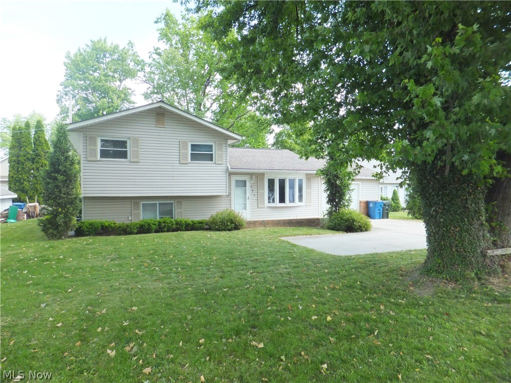 Enjoy lake breezes from this charming 3 bedroom 1 1/2 bath split-level home in desirable Sheffield Lake. Built in 1971, this single-family home offers approximately 1,068 sq ft of living space with a 1-car attached garage. Inside, you'll find a large kitchen with sliding doors to outdoor patio, comfortable living areas, central air, forced-air gas heat, and included appliances such as dishwasher, range refrigerator, washer and dryer. The home also features vinyl exterior siding, a paved driveway with turnaround