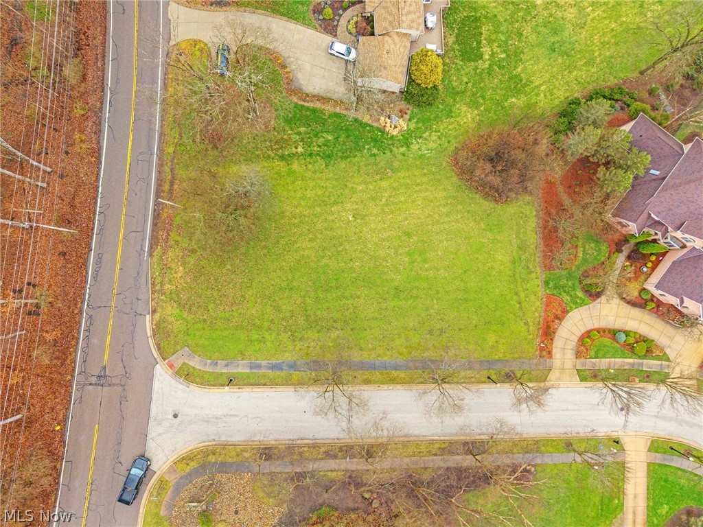 Rare opportunity to buy the only vacant lot available to build in prestigious Merriman Woods - one of Akron's best neighborhoods filled with high end homes, located in an ideal area close to Sand Run Metro Parks and Merriman Valley.  This corner lot features a drop in elevation towards the back of the parcel - creating opportunity to enjoy breath taking protected views of dropping elevation that will never be built on. Ideal set up for a walk out basement. This neighborhood is filled with homes selling north of $600,000, a great walking neighborhood with sidewalks and natural beauty.  This neighborhood has direct access to a easement to enter onto the Tow Path without driving - imagine an evening walk, jog, or bike ride where you can walk down the street and jump right on the tow path and enjoy.  Close to all of the amazing Metro Parks, this lot is fully improved with water and sewer laterals already run into the lot.  The small HOA fee covers leaves, entrance and shared space maintenance.   The current owner has already completed a full topographic survey that transfers and had a gorgeous custom house design built specifically for the lot that can be included with the sale if desired.  Seller's moving plans changed, otherwise this lot is prime for a dream home which is located in Akron's 15 year, 100% Tax Abatement - meaning once you build you will pay property tax on land value only for 15 years - not the improved house value!  That savings could amount to over 100,000 over 15 years, and the abatement is fully transferable - essentially paying for the lot itself.  This .38 acre parcel is priced just under the appraised value by the city and creates an ideal opportunity for a dream home to be designed with captivating views in a prestigious neighborhood and location, with incredible long term tax savings.  Bring your own builder or let me introduce you to one - call for more details! Listing agent related to seller.