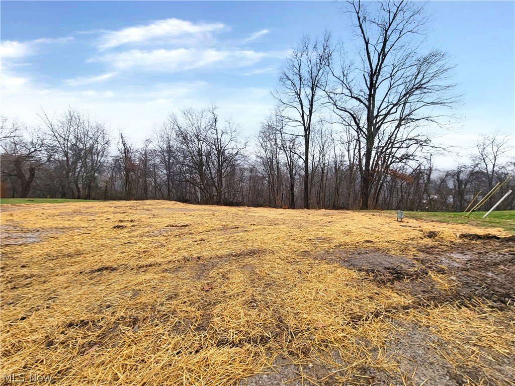 0.36 +/- acre gently sloped residential building lot with 90' +/- of road frontage. Prior home has been razed and lot is ready for new construction with all utilities available.