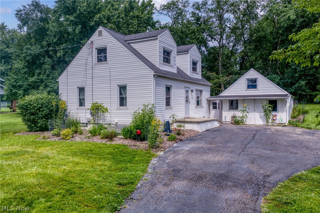 Welcome to this beautifully updated home. As you come into this inviting Cape Cod style home with vintage style arches and beautiful hardwood floors. This home has lovely custom kitchen cabinets and large eat in kitchen. The living rm has beautiful hardwood flooring, archways and stairs to second floor. The first floor renovated full bath has tile accents and the first floor is rounded out with two nicely sized bedrooms with hardwood flooring. Second floor has two recently updated bedrooms and a beautifully updated half bath. The  HUGE garage/ outbuilding has  walk up attic space for office, hobbyist or storage. The back yard has been transformed into your private oasis with a beautiful stamped concrete and teared perennial gardens, all surrounded by fencing to help keep out those animals who love it as their own garden buffet. The current owner has purchase the additional lot that was split from the property previously and that is included in this sale, the upstairs half bath and two bedrooms have been updated and new LVF installed. Come see this one now as it will not last!!