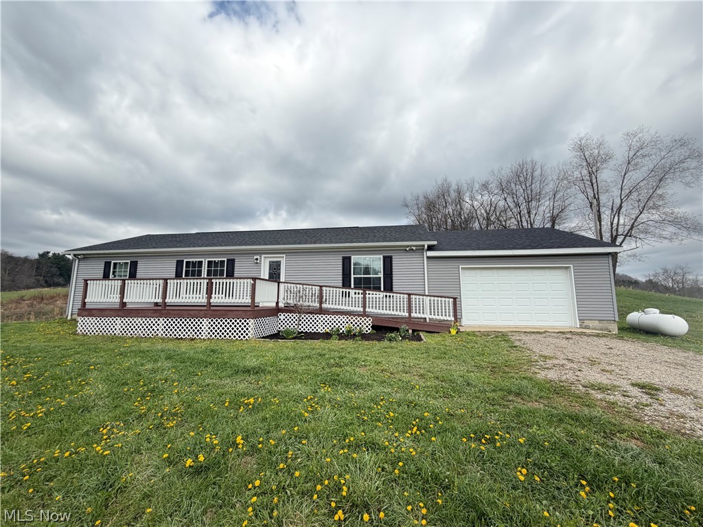 Welcome to peaceful country living in this beautifully maintained, move-in ready home! Situated on 2 acres, this 3-bedroom, 2-bath home offers the perfect blend of modern comfort and open space. Step inside to an inviting open-concept layout featuring a spacious living area that flows seamlessly into the kitchen—complete with stylish cabinetry, ample counter space, and a large island perfect for entertaining. The one-floor design provides convenience and accessibility, including a dedicated laundry room for added ease. Enjoy morning coffee or evening sunsets from the large front porch overlooking scenic countryside views. The attached two-car garage offers plenty of storage and everyday convenience.Home also comes with a Generac generator that will sustain entire home in the event electric should go out. Call today for a private showing!
