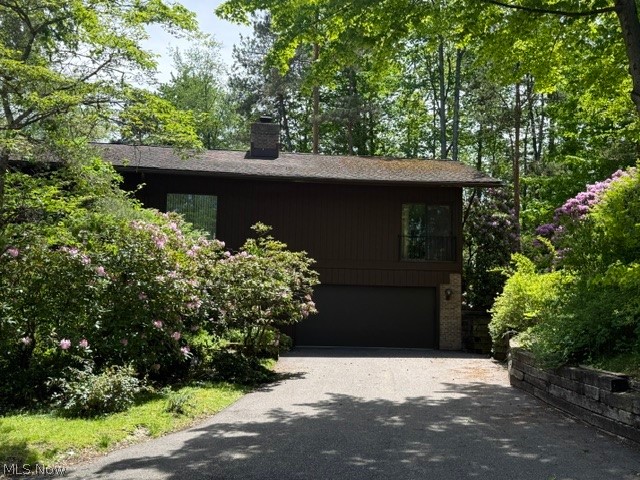 Welcome to 1938 Hemlock Dr Kent Ohio. This stunning 3 bedroom 2 full and 1 half bath condo has so much to offer. It is located in a quiet secluded comfortable nature setting. In fact, The Pines is a designated wildlife habitat. This condo has vaulted ceilings, beams, and an open floor plan. Entering the home, you will see a beautiful 2 story foyer with a see-through brick fireplace. The first floor has 2 bedrooms, a laundry room with shelving, and bath and garage access. This first floor could be used as an additional living suite. Entering the second floor you have vaulted ceilings, a master suite with a walk-in closet and full bath with double sinks. The formal dining room has spacious views and a balcony. The L shaped kitchen is complete with quartz countertops and ceramic tile floors and an eat in area. The guest bath and the wet bar have marble countertops.  The great room is a GREAT room, large with natural light and the fireplace. This condo is a must see! Call today!