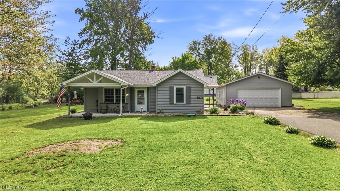 3635 Homewood Ave., Hubbard, Ohio, a well maintained and thoughtfully updated 2 bedroom, 1 bathroom home located in Hubbard Township within the Hubbard School District. This charming property offers excellent curb appeal with newer vinyl siding, a dimensional shingled roof, and a welcoming covered front porch with gabled roofline perfect for relaxing outdoors. The exterior continues to impress with a large 2.5 car garage, oversized 2 car wide blacktop driveway, and a covered back deck overlooking the heated above ground pool creating a great space for entertaining and summer enjoyment. Inside, the kitchen welcomes you with wood cabinetry, high-definition Formica countertops, vinyl plank flooring, and a convenient breakfast peninsula for additional seating and prep space. The kitchen flows nicely into the comfortable living room featuring carpet flooring and a cozy feel for everyday living. One bedroom is located just off the living room offering carpet, double closet space, and access to the furnace room, while the second bedroom provides carpet flooring and a single closet. Toward the back of the home is a spacious family room with vinyl plank flooring and sliding glass door access to the covered back deck and pool area allowing plenty of natural light and additional living space. Just off the family room is the laundry and water treatment room (Kinetico water softener and reverse osmosis drinking water) for added convenience. The full bathroom includes a tub surround and vinyl plank flooring. Additional features include a 100 amp electrical panel and numerous updates completed throughout the years making this home move-in ready and easy to maintain.