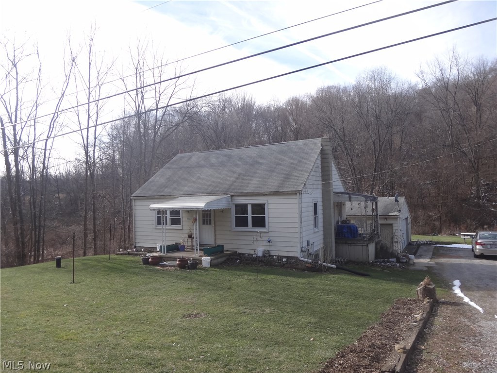 POSSIBLE LAND CONTRACT! Are you just starting out or wanting to downsize?  This may be the right home for you!  This aluminum sided ranch features an all applianced eat-in, updated kitchen, living room, two bedrooms and an updated full bath all on one floor.  Current owner is using the second bedroom for a first floor laundry room, but could be changed back to a bedroom. Hardwood floors under newer carpeting.  Full walk-out basement.  Forced air oil furnace, hot water tank, water softener, updated electrical and plumbing in basement.  Vinyl windows approx. 9 yrs. old.  Newer roof on back side of home.  Two car detached garage with lean to for additional storage.  Garage door and opener less than 4 yrs. old.  All of this sitting on over an acre of ground located in Beaver Local School District.  Small creek to the rear of the property.  Shared driveway.