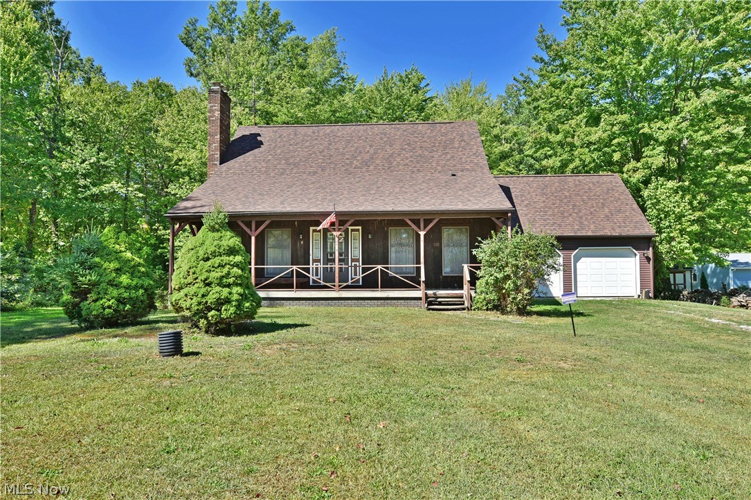 Find beautiful, natural serenity and two floors of finished living space in this impressive, five-bedroom Braceville Township home! Set deep into a tree filled property, the handsome home displays an engaging, cabin styled look with its dark brown siding and gable lined, covered front porch; poised for warm weather relaxation. Meanwhile, a two-car attached garage resides at the end of the gravel drive. Step into the brightly lit foyer to find the carpeted staircase sweeping towards the quartet of second-floor bedrooms. The spacious living room branches away with its lush carpets and stunning brick fireplace. A partition wall divides the nearby formal dining area offering backyard views. Enjoy the impressive nearby kitchen with its center island and array of wooden cabinetry. Room for casual dining is located at the far corner. First-floor laundry is seen near the garage and backyard access. A spacious master bedroom with a huge walk-in closet completes the floor as it shares a full pri