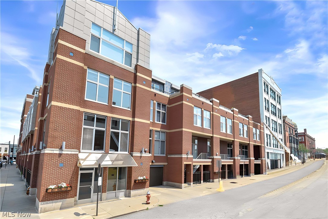 Beautifully updated 2-story penthouse with MILLION DOLLAR VIEWS of downtown Cleveland and Lake Erie.   It is rare that a corner unit enjoys North, East, West, and South views including SUNRISE AND SUNSETS.   Located across the street from the Westside market and in the heart of the historically significant Ohio City neighborhood.   Walk to restaurants, brew pubs, coffee shops and local retail.  You will appreciate all the recent updates starting at the freshly painted foyer.  To the right of the front door, is the discreetly located laundry.  The full bath on first floor has been freshened.  A rare yet under-utilized pantry has been re-imagined.  New custom drapes have been installed on the floor to ceiling windows.  Windows also have solar roller blinds and are tinted for UV protection and privacy.  Open floor plan with surround sound will remain along with all controls (music only).  The LR and DR have newer engineered maple wood flooring, a gas fireplace and a flat screen TV which will remain.  The open kitchen with a breakfast bar is a cook’s delight with newer CAFÉ appliances, granite counters and a stylish glass backsplash.   The first floor bedroom retreat includes private terrace access.  The upstairs bedroom has another fireplace and wall mounted, flat screen TV (stays) and is currently used as a study/library.  A generous terrace extends the second floor with gorgeous lake views and magical sunsets. The owner has also paid $46K for the new roof installed 2025.  The upstairs dressing room (WIC) has been remodeled and freshly painted.  The flush mount lighting was reconfigured.  The upstairs bathroom has a Jacuzzi soaking tub and separate shower, and a double sink vanity with granite counters.  Newly installed, neutral wallpaper and a custom window treatment finish this area.  Carroll Avenue Condos has common areas and an exercise room.  This suite has two, conveniently located parking spaces (#56 & #57) and a storage locker (#517).