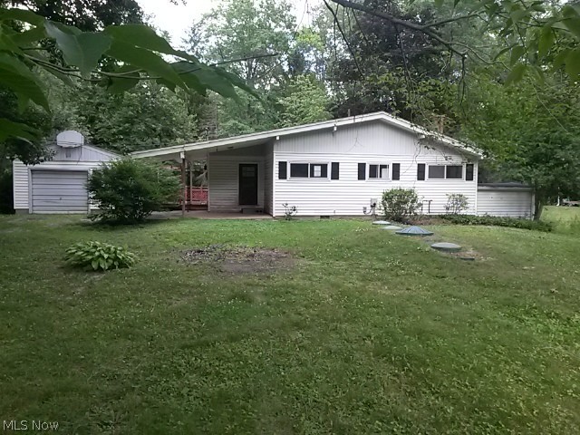 This two bedroom ranch offers large living room with fireplace, eat in kitchen and large sun room over looking the stream.  Scenic back yard with boat dock, and bridge leading to secluded area.  large deck, garage with work shop.  Water fee is $25 per month, Road maintenance fee is $55 per year.  There is a $100 optional fee for lake privileges.