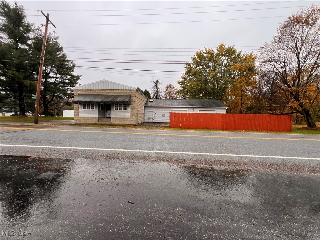 Versatile one-story commercial-zoned property located in the Crestview Local School District offers endless possibilities for residential or business use. The main level features a welcoming foyer, office area, fully renovated bathroom, and a kitchen equipped with a refrigerator, stove, and microwave. An additional room with a wood stove could serve as a sitting area or flexible workspace.

The interior has been updated throughout with new luxury vinyl plank flooring, brand new carpeting in two rooms, and ceramic tile in the foyer. The full basement provides excellent storage and includes a laundry area and a finished recreation room.

An attached oversized garage with a built-in workshop area and interior access to the basement provides plenty of functional space for work, storage, or vehicles. Additional parking is available with both asphalt and off-street options. The extra rear parcel houses the well and septic system and is zoned residential.

Exterior features include a fenced-in yard with privacy wood fencing on the side and back, a chain-link fenced front area with a gated entrance to the two-car garage, and ample space for a variety of potential uses. This vacant property is ready to accommodate your vision—whether for business, residential, or mixed-use purposes.