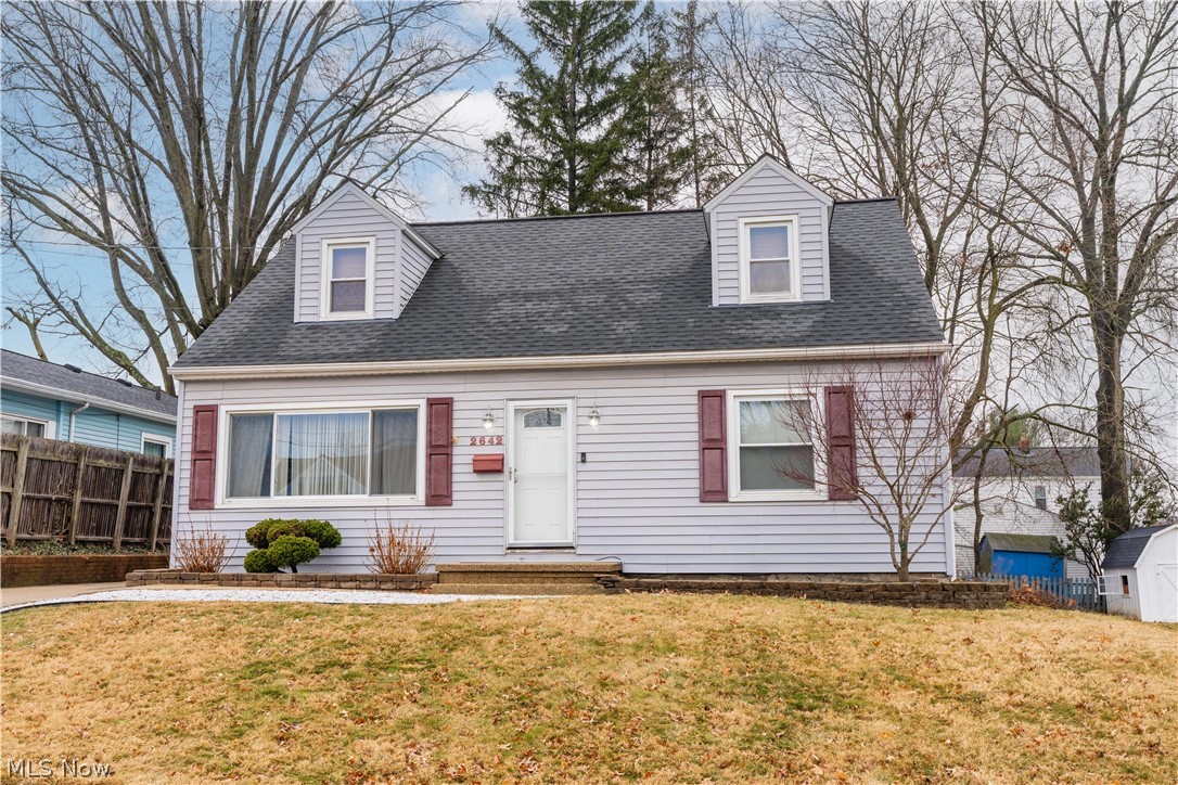 Charming Cape Cod with a 2-car garage and spacious rooms throughout! The main level features a large family room, kitchen with appliances, dining area, full bathroom, and two comfortable first-floor bedrooms. The second floor offers a generously sized primary suite with great closet space and classic dormer character, or it can easily function as a large bonus room, office, or additional living space. The finished lower level provides additional recreation space and includes a bar area, making it ideal for entertaining, game nights, or a secondary gathering area. Outside, enjoy a private backyard with patio space perfect for relaxing or hosting guests. The above-ground pool will remain with the home and adds to the outdoor enjoyment. Additional highlights include extra concrete parking, offering plenty of space for vehicles or guests. A wonderful opportunity to own a charming Cape Cod with versatile living space inside and out.