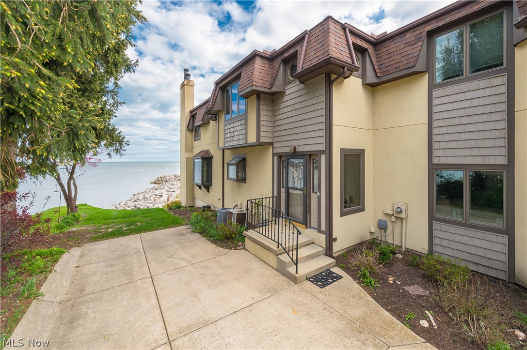 Experience true lakefront living with nearly 3,000 square feet of beautifully designed space, perfectly positioned as the closest condo to the water in the lovely Compass Rose community. With multiple vantage points of Lake Erie, this home offers a lifestyle that's hard to replicate. The main level welcomes you with a spacious entry foyer just off the attached garage. The eat-in kitchen down the hall leads into an expansive living area featuring a cozy fireplace, recessed lighting, and sliding glass doors that open to a private balcony- Ideal for enjoying the sights and sounds of the lake. A half bath finishes this level. Upstairs, the primary suite serves as a private retreat, complete with its own walk-out balcony overlooking the water, a generous walk-in closet, and an en-suite bath featuring a convenient stackable washer and dryer. Two additional bedrooms and a full bath complete the upper level for guest space or an office. The finished lower level is features new LVP flooring, a second fireplace, wet bar, laundry area, and full bath perfect for entertaining, hosting family or relaxing on summer evenings. Sliding glass doors lead directly outside to the patio just steps from the shoreline. Residents of Compass Rose enjoy exclusive access to a private beach and in-ground pool, making every day feel like a getaway. Fresh paint throughout! Make a few of your own cosmetic updates and enjoy the rare opportunity to own one of the closest waterfront units in Vermilion. Just minutes from Downtown shops and restaurants and not far from the Lake Erie Islands and Cedar Point! Don't miss your chance to make this exceptional lakefront condo yours.