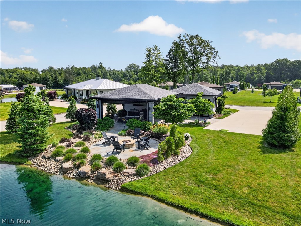 Luxury Motorcoach Living along the shores of Lake Erie: Lake Erie Shores Luxury Motorcoach Resort - Phase 2, RV Lot 44: This stunning property on the edge of Deer Lake features a Craftsman-style bungalow that's just the right size. High rise walls and doors supply abundant volume to the living space of this Alexa smart home. 1B/1B boasts beautiful finishes of Italian wood-look tile throughout, gorgeous efficient kitchen with Quartzite counters, convection microwave oven, induction cooktop, dishwasher, ss frig, tankless reverse osmosis water drinking water supply, electric fireplace, white framed smart TV, remote window shads and real wood blinds, full bath, custom wardrobe wall, 2 mini splits, combo washer dryer, on-demand hot water unit, water softener. Outdoors gorgeous custom landscaped lot w/irrigation, landscape lighting, pretty courtyard, golf cart garage, lanai with outdoor kitchen, furniture, grill, bluestone floor, motorized remote screens and shutters. Meander down the walkway to the waterfront patio. Relax alongside Deer Lake, view the tranquil fountain and sit around the natural gas fire pit surrounded by black poly Adirondack chairs. Sip a glass of wine with friends/family while taking in all the beauty and nature that abounds. Pull in pad with utility hook ups. Exterior furniture conveys, interior furnishings are negotiable.
Access to pool, hot tub, clubhouse with coffee bar, fitness room, gourmet club kitchen, pickle ball courts, community activity all included. Close to 30+wineries, distilleries, Geneva-on-the Lake, Lake Erie marinas, fishing, Spire, Historic Ashtabula Harbor restaurants, galleries, shops, Cleveland Sporting events, museums, Play House Square theatre district. 
Additional vacant lots starting at $169,900 are available along with other resale properties with various build outs to meet your needs and budget.