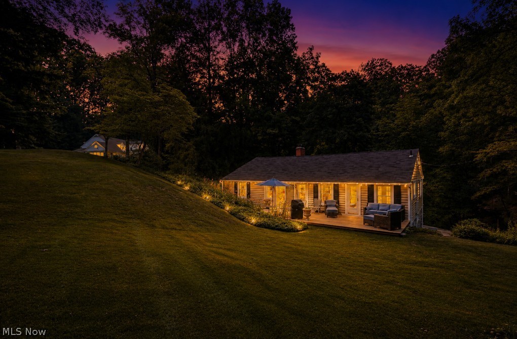 Escape to this unique 8+ acre private nature retreat in the heart of Bath Township (and part of the Yellow Creek Corridor). This extraordinary property features two separate near-century homes. While both are set back considerably from the road, the cottage-style home—situated in the forefront and one of the first built on the street—is a charming 2-bedroom raised ranch at 2803 Yellow Creek, affectionately known as "The Tree House”. The second home is nestled at the back and top of the valley and is a grand, spacious 4-bedroom split-level at 2801 Yellow Creek—making it ideal for multigenerational living, a home/office compound, or as an income-producing asset. This rolling landscape ensures excellent privacy and separation between the homes while sharing a driveway. In a sought-after neighborhood, the grandfathered status allowing two homes on one property is rare to the area, offering a legacy estate like no other. Towering Oak, Spruce, Buckeye, Walnut, and Chestnut trees create a breathtaking natural canopy, while lush foliage and frequent wildlife visits make every season feel like an escape. In the raised ranch, expansive picture windows frame the woods, creating the perfect setting to relax beside the wood-burning fireplace on a snowy winter day. The inviting sunroom opens to a newly refurbished deck. On this rare estate-sized property, additional features include a barn with electricity and two whole-home standby generators. Tucked away in a serene setting but minutes from I-77, it is conveniently located near local shopping and neighborhood favorite dining spots like Lannings and Gasoline Alley. Most notably, the property is located only 2 miles from the nationally recognized Cuyahoga Valley National Park, famous for its lush forests, historic locks, and direct access to the 90+ mile Towpath Trail. All of the unique attributes accompanying these two homes make it a truly exceptional opportunity to own one of the area's most distinctive properties.
