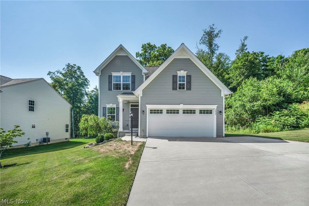Nestled on a premium lot with wooded views and privacy in both the front and backyard in the desirable Liberty Ledges community within the award-winning Twinsburg School District, this beautifully maintained Colonial offers over 2,887 sq ft of finished living space, including a finished basement, plus numerous thoughtful upgrades throughout. Enjoy outdoor living on the low-maintenance composite deck with pergola and adjoining patio. The open-concept main level features an eat-in kitchen with stainless steel appliances, center island with breakfast bar, tile backsplash, and custom built-ins, flowing seamlessly into the family room and dining area with direct access to the deck. An additional flex room provides the perfect space for a home office, formal living room, dining room, or den. A finished mudroom with built-ins adds everyday convenience. Upstairs you'll find 3 bedrooms, a spacious loft that can easily be converted into a 4th bedroom if needed, and the convenience of second-floor laundry. The primary suite offers two walk-in closets and a private bath with a double vanity and walk-in shower. The finished lower level expands your living space with a large recreation room featuring a built-in rock-climbing wall, projector screen, surround sound speakers, plus extra living space and storage. Updates since moving in include the finished basement, composite deck and patio with retaining wall, landscaping, extended driveway pad, hardwired security system, finished mudroom, custom kitchen built-ins, updated main-level flooring, dishwasher, and more. Included are all kitchen appliances, family room TV mount and soundbar, basement projector screen, projector mount (projector excluded), built-in surround sound speakers, mounted shelving, pergola, retractable deck gate, and a one-year home warranty. Conveniently located near I-480, OH-91, schools, parks, shopping, restaurants, and everyday conveniences.