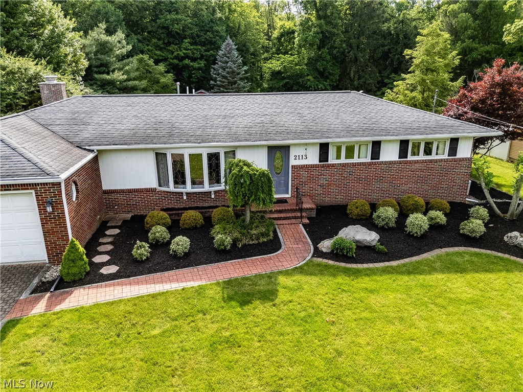 Country charm meets convenience in this spacious all-brick ranch nestled against a scenic wooded backdrop. Offering 3 bedrooms, 2 full baths, and over 700 square feet of finished basement space that includes a possible 4th bedroom, this home provides room for everyone. The inviting great room addition with brick fireplace, finished lower-level recreation area, and expansive enclosed porch create the perfect setting for hosting holidays and special gatherings. The kitchen features Corian countertops, while hardwood floors enhance the bedroom spaces. Step outside to a brick paver patio and enjoy peaceful nature views from your private backyard retreat. Located just minutes from Norwalk amenities, Eagle Creek Golf Course, and Cameo at The Creek.